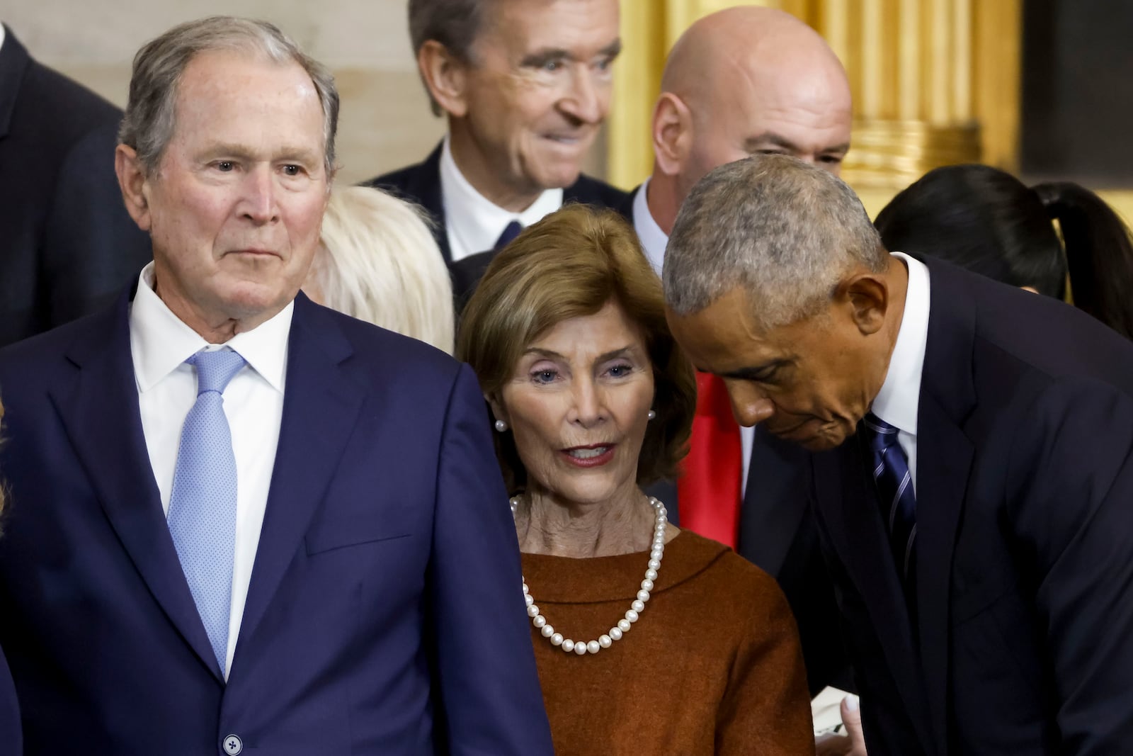 Former President George W. Bush, former first lady Laura Bush and former President Barack Obama, speak after President Donald Trump was sworn in during the 60th Presidential Inauguration in the Rotunda of the U.S. Capitol in Washington, Monday, Jan. 20, 2025. (Shawn Thew/Pool photo via AP)