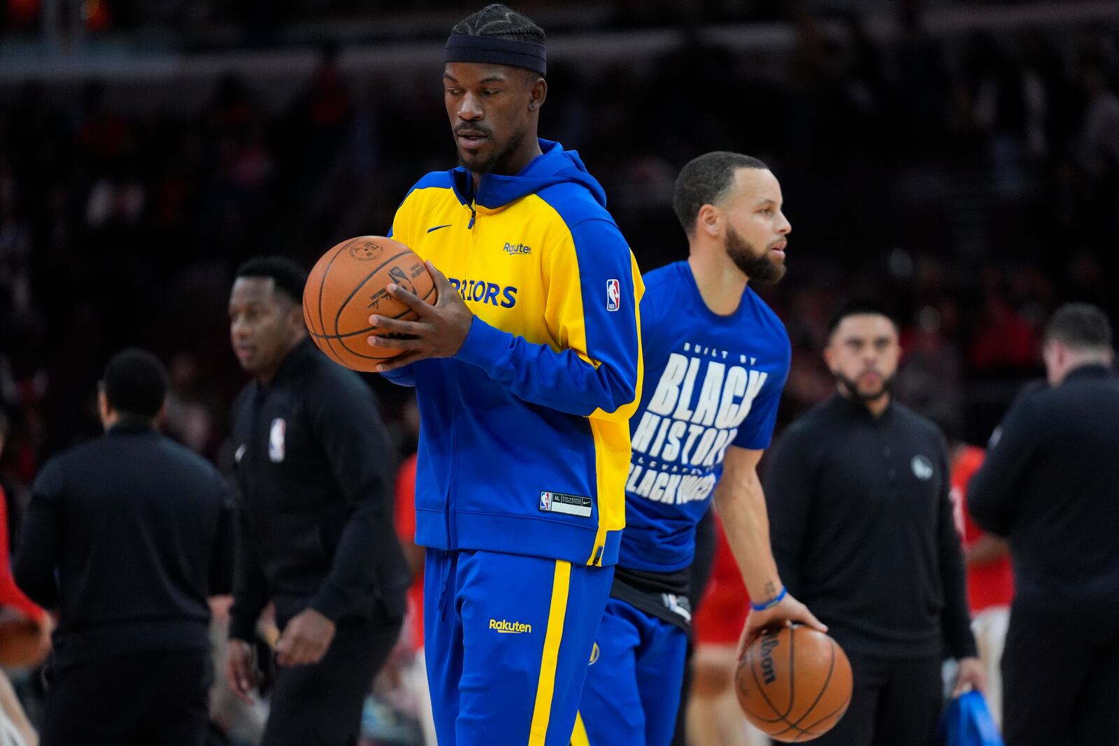 Golden State Warriors forward Jimmy Butler, left, and guard Stephen Curry, right, warm up before an NBA basketball game against the Chicago Bulls, Saturday, Feb. 8, 2025, in Chicago. (AP Photo/Erin Hooley)