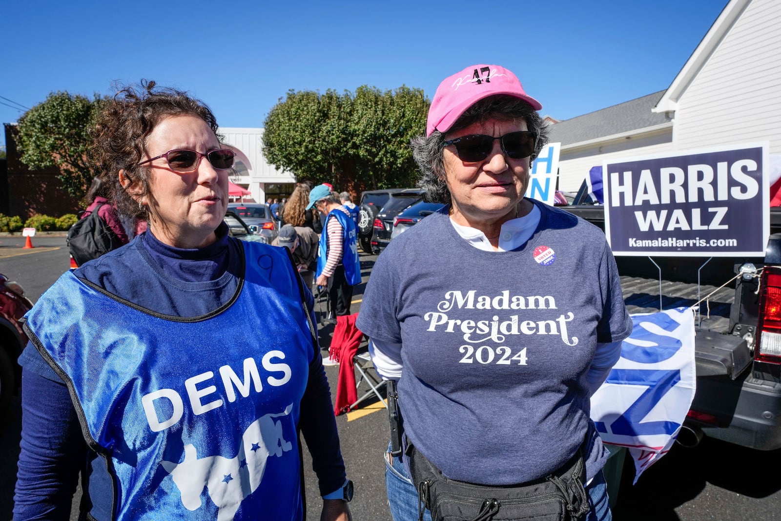 Supporters for Vice President Kamala Harris, Juliette Delgado, left, and Toni Mangan, both of Rutherford County, outside the Rutherford County Annex Building, where early voting was taking place, Thursday, Oct. 17, 2024 in Rutherfordton, N.C. (AP Photo/Kathy Kmonicek)