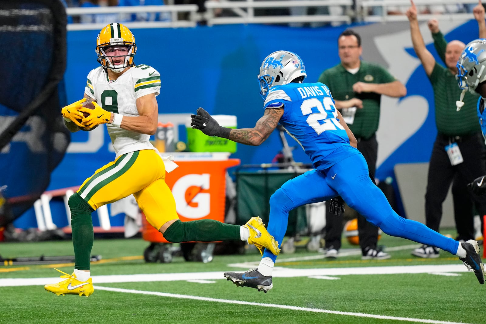 Green Bay Packers wide receiver Christian Watson (9) makes a catch in front of Detroit Lions cornerback Carlton Davis III (23) during the second half of an NFL football game in Detroit, Thursday, Dec. 5, 2024. (AP Photo/Carlos Osorio)