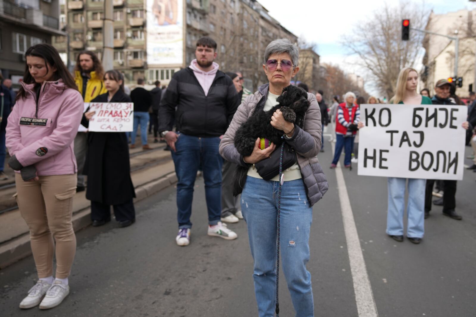 People stopping traffic, stand in silence during ongoing protests that erupted after a concrete canopy fell in the November and killed 15 people in Belgrade, Serbia, Wednesday, Jan. 29, 2025. (AP Photo/Darko Vojinovic)