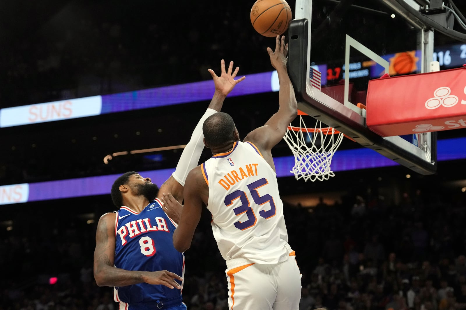 Phoenix Suns forward Kevin Durant (35) scores over Philadelphia 76ers forward Paul George (8) for the game-winning basket in the second half of an NBA basketball game Monday, Nov. 4, 2024, in Phoenix. The Suns won 118-116. (AP Photo/Ross D. Franklin)