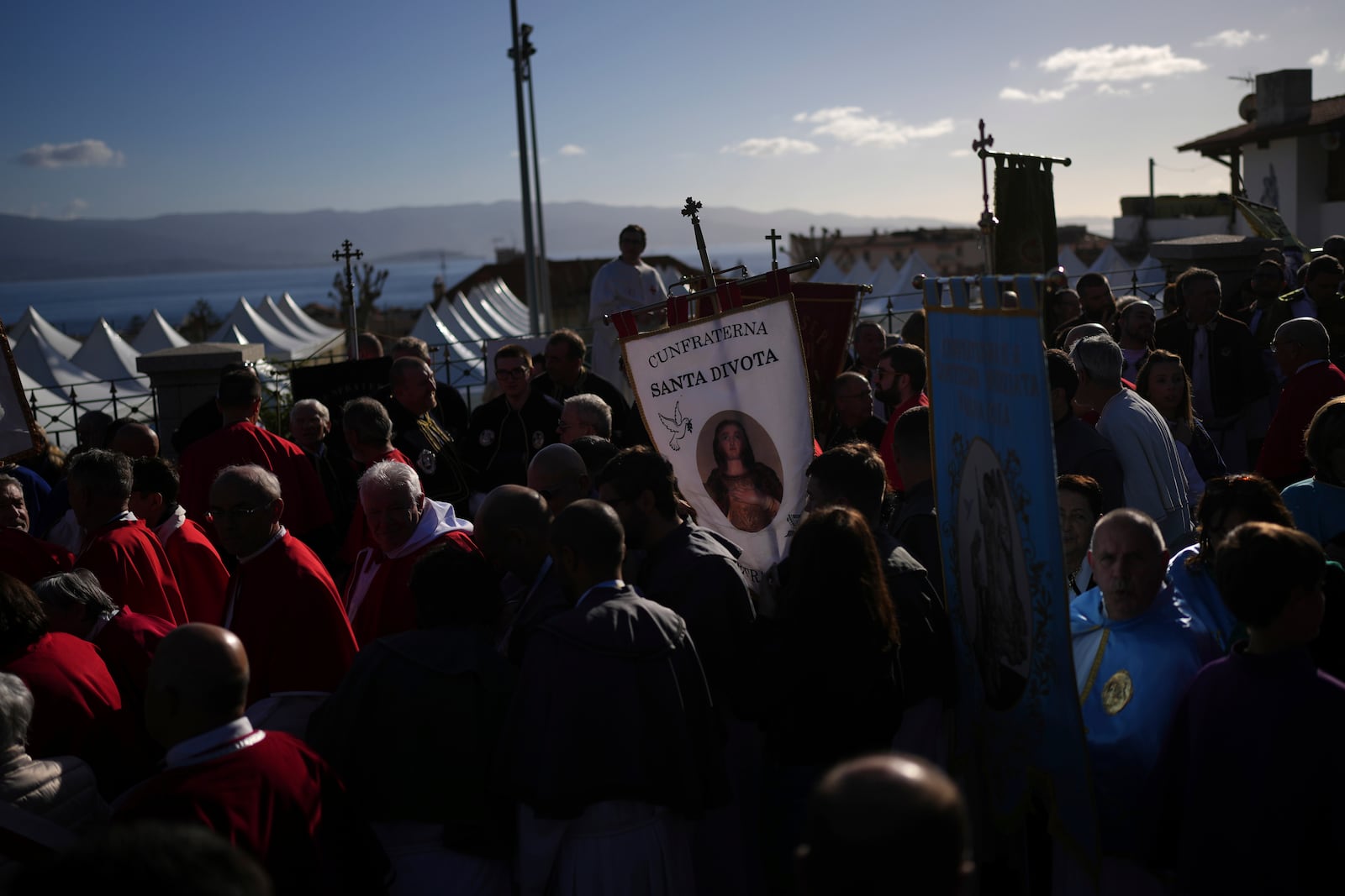 Faithful gather Sunday, Dec. 15, 2024 in Ajaccio, Corsica island, as Pope Francis' one-day visit to Corsica puts a dual focus on the Mediterranean, highlighting local traditions of popular piety on the one hand and migrant deaths and wars on the other. (AP Photo/Thibault Camus)