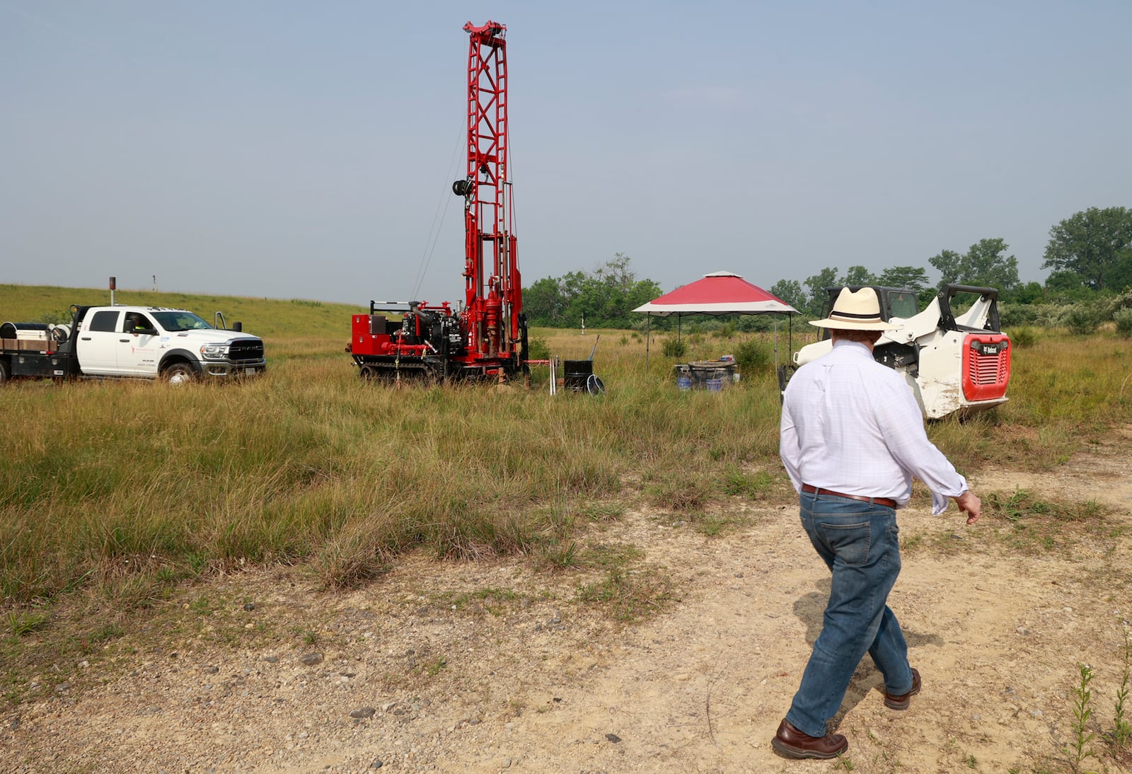 Springfield City Commissioner David Estrop walks around the drilling operation at the Tremont City Barrel Fill site in June 2023. BILL LACKEY/STAFF