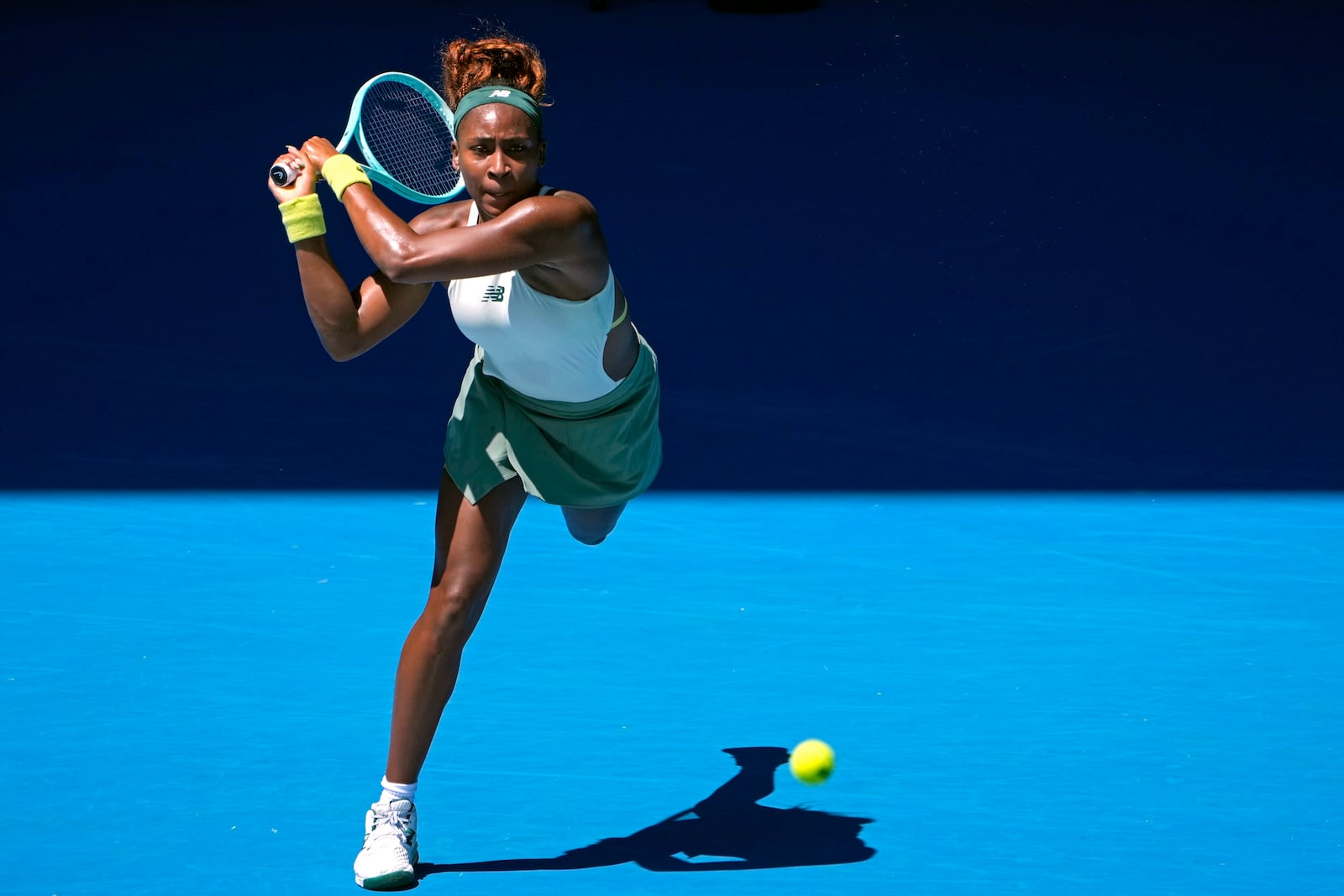 Coco Gauff of the U.S. plays a backhand return to Sofia Kenin of the U.S. during their first round match at the Australian Open tennis championship in Melbourne, Australia, Monday, Jan. 13, 2025. (AP Photo/Asanka Brendon Ratnayake)