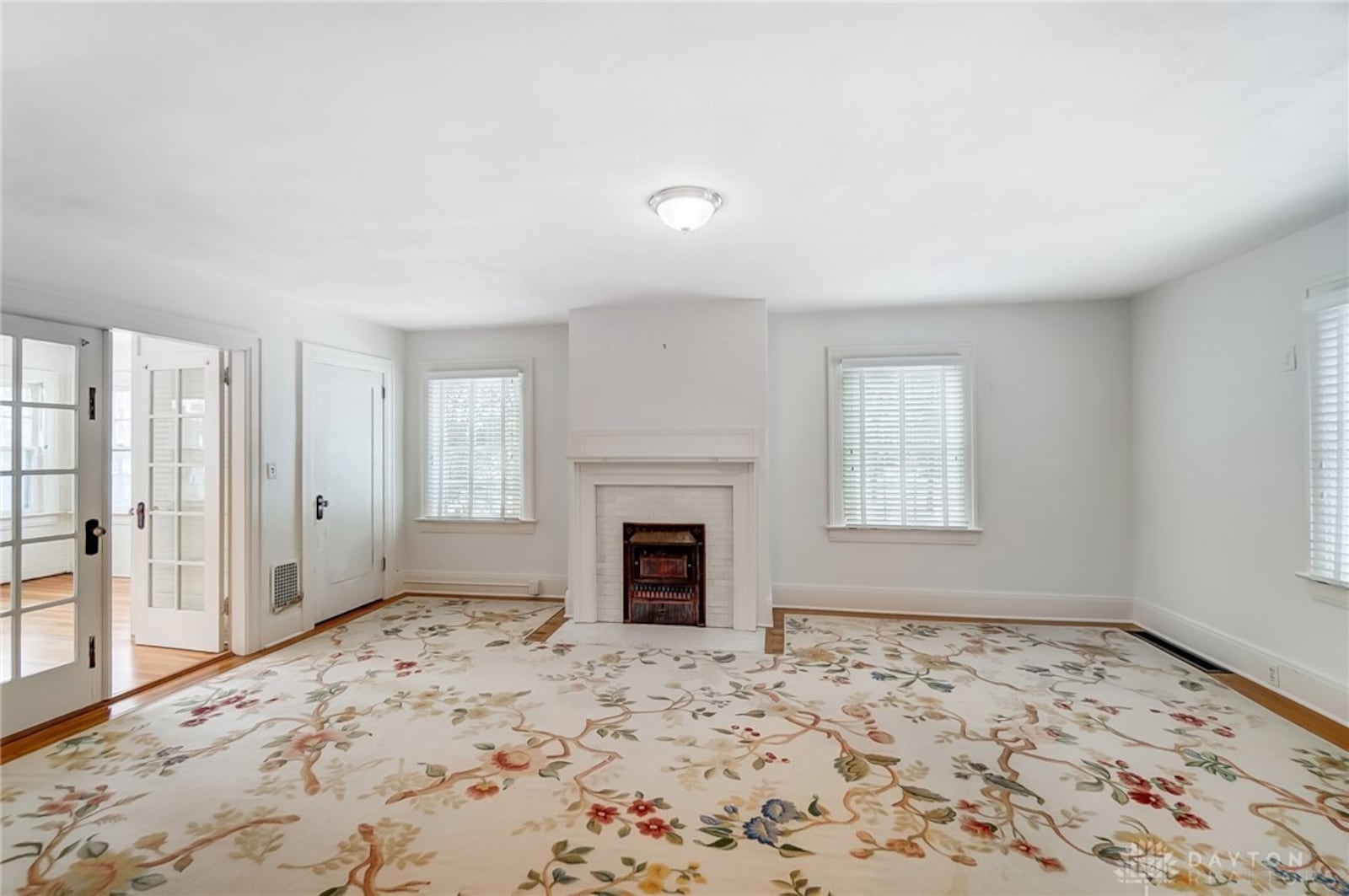 The primary bedroom suite is on the second level and has an attached sun room through French doors. There is also an ensuite bathroom and decorative fireplace.