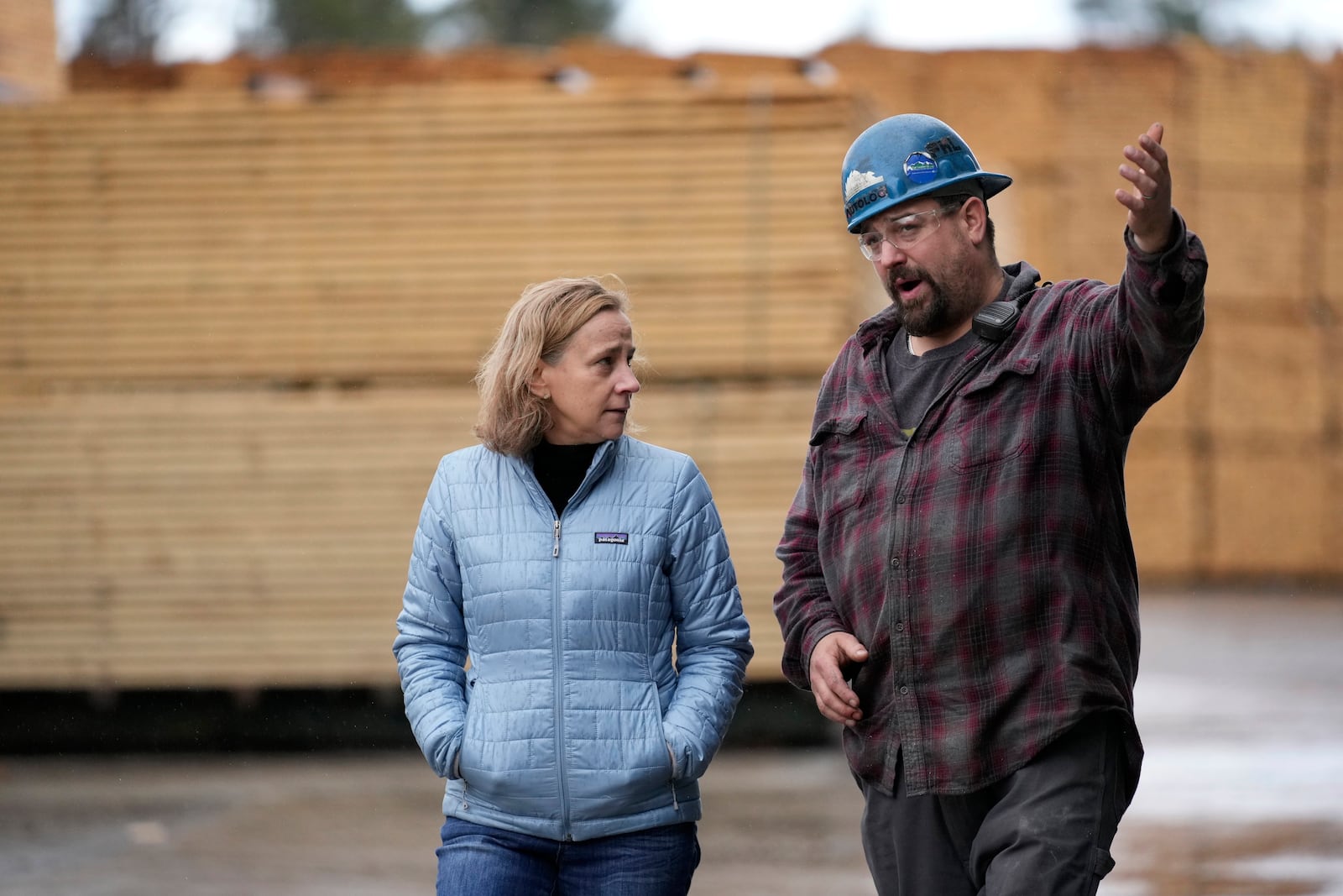 Joyce Craig, Democratic candidate for governor, talks with sawmill manager Joey St. Onge during a visit to the Milan Lumber mill, Wednesday, Oct. 16, 2024, in Milan, N.H. (AP Photo/Robert F. Bukaty)