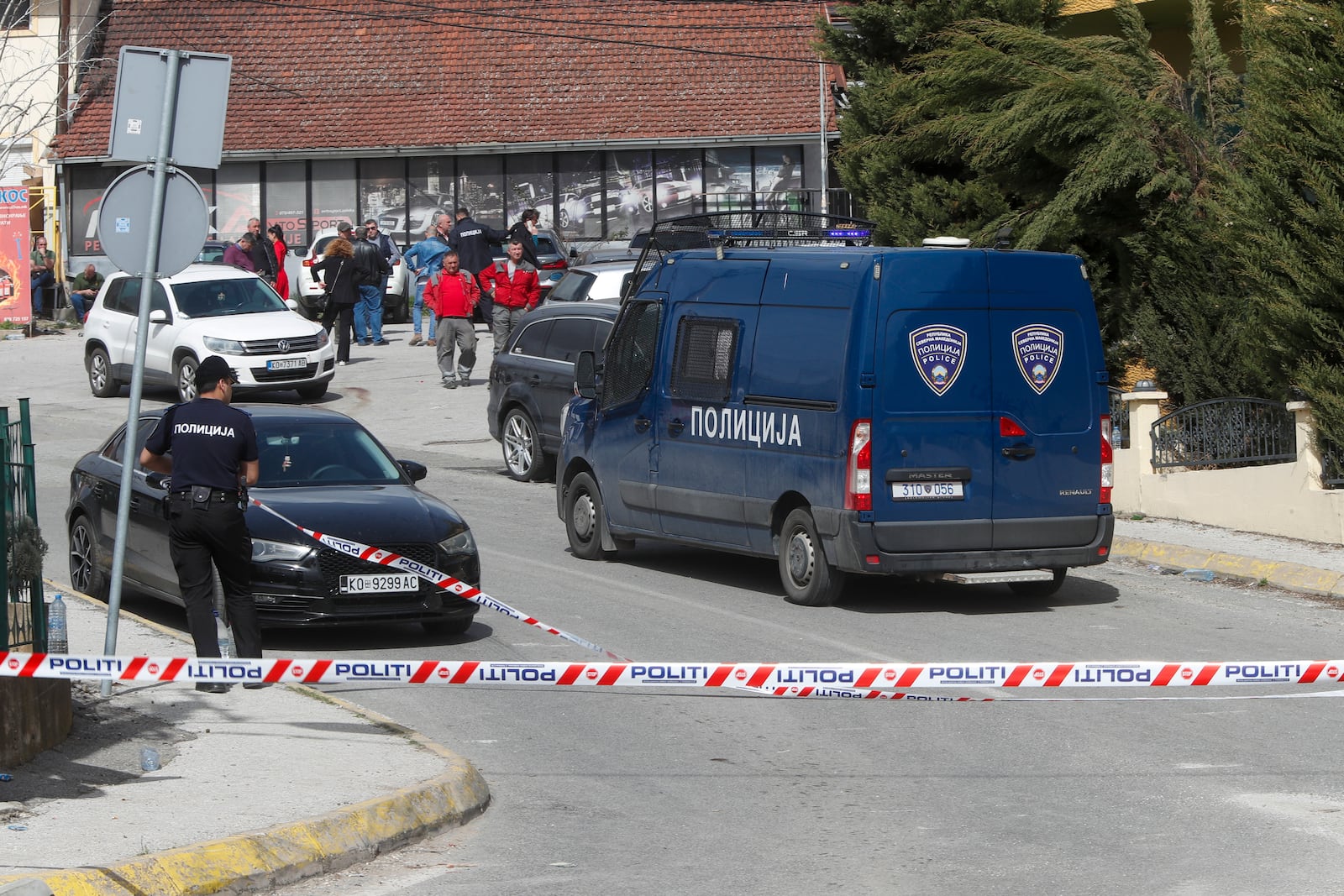 Police officers block a road near a nightclub after a massive fire in the town of Kocani, North Macedonia, Sunday, March 16, 2025. (AP Photo/Boris Grdanoski)