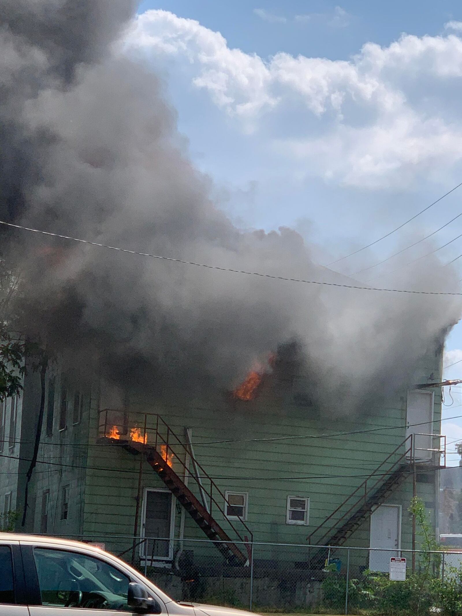 Flames shoot through the roof in a house fire on East Mulberry Street in Springfield on Friday, June 9, 2023. EMILY PARSONS/CONTRIBUTED