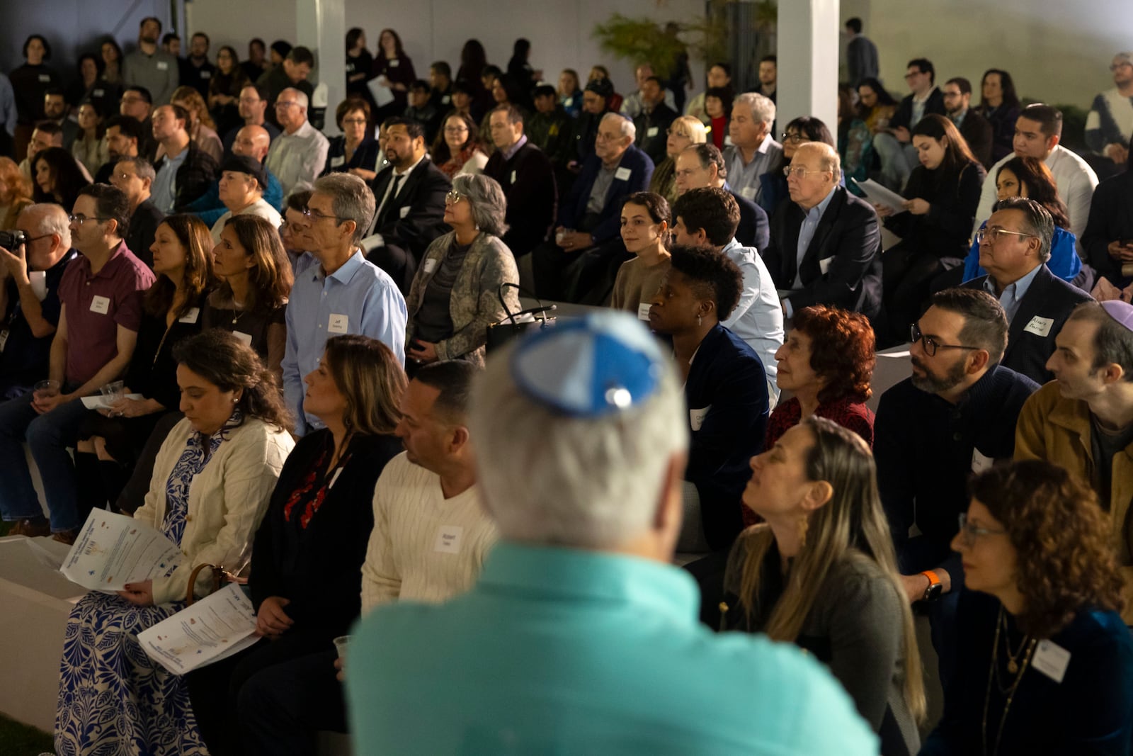 Guests listen to speakers during a Chicanukah event at Holocaust Museum Houston on Thursday, December 19, 2024, in Houston. (AP Photo/Annie Mulligan)