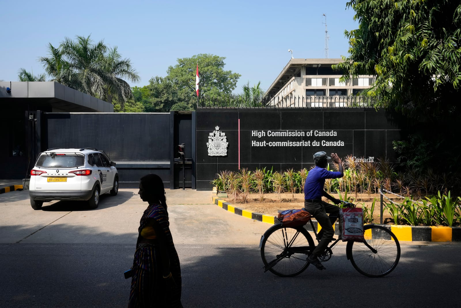 A cyclist pedals past the Canadian high commission in New Delhi, India, Tuesday, Oct. 15, 2024 after India and Canada expelled each other’s top diplomats over an ongoing dispute about the killing of a Sikh activist in Canada. (AP Photo/Manish Swarup)