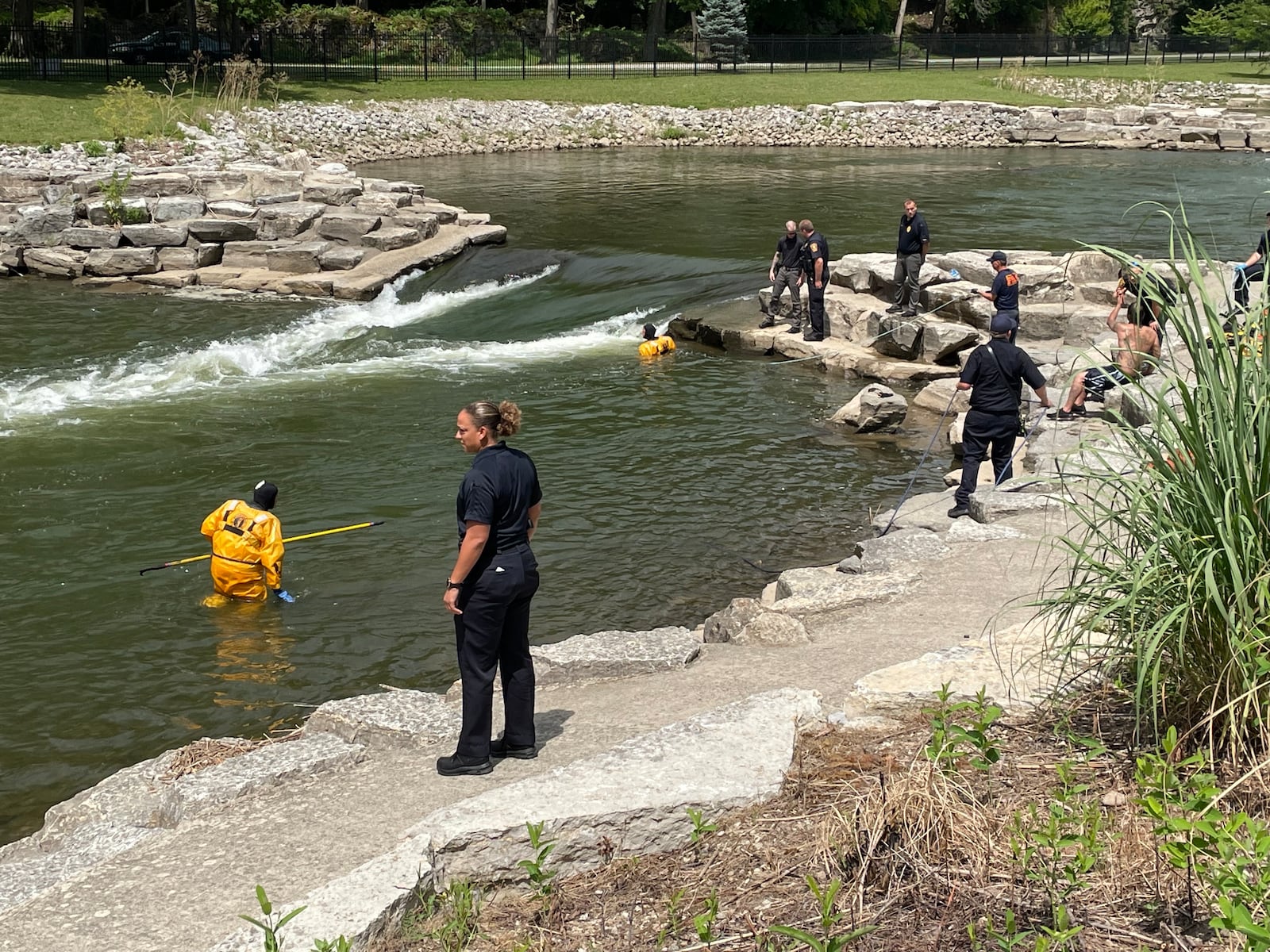 The Springfield Fire Division searches Buck Creek for a man reported to have not resurfaced after going underwater Friday afternoon, July 15, 2022. BILL LACKEY/STAFF