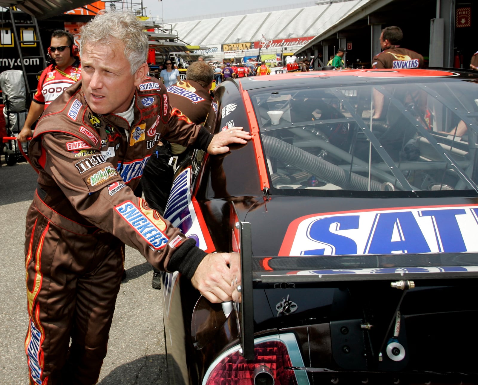 FILE - NASCAR driver Ricky Rudd pushes his car with members of his crew into the garage during practice for the Autism Speaks 400 auto race at Dover Speedway in Dover, Del., Friday, June 1, 2007. (AP Photo/Carolyn Kaster, File)