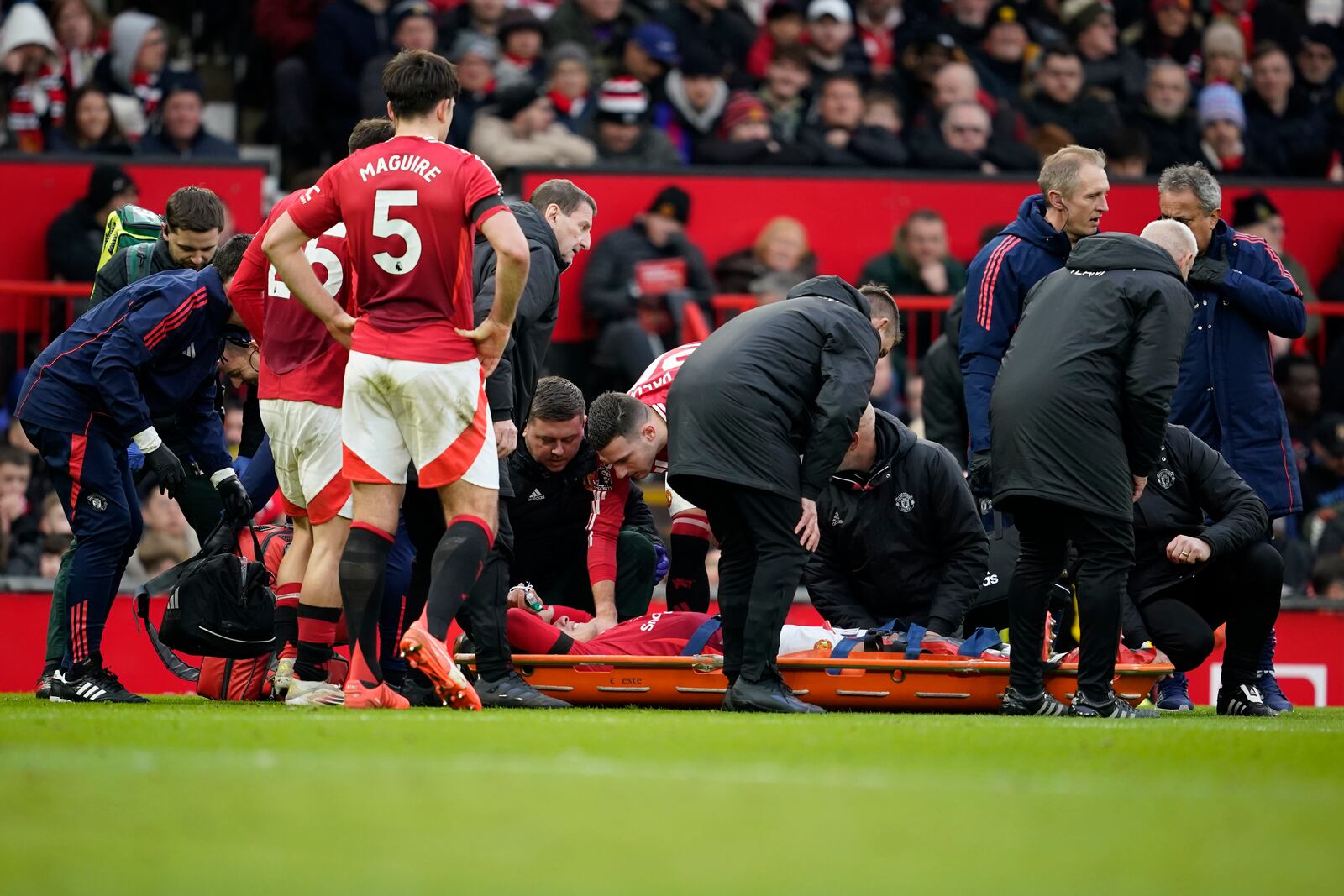 Manchester United's Lisandro Martinez lies on a stretcher after an injury during the English Premier League soccer match between Manchester United and Crystal Palace at Old Trafford stadium in Manchester, England, Sunday, Feb. 2, 2025. (AP Photo/Dave Thompson)