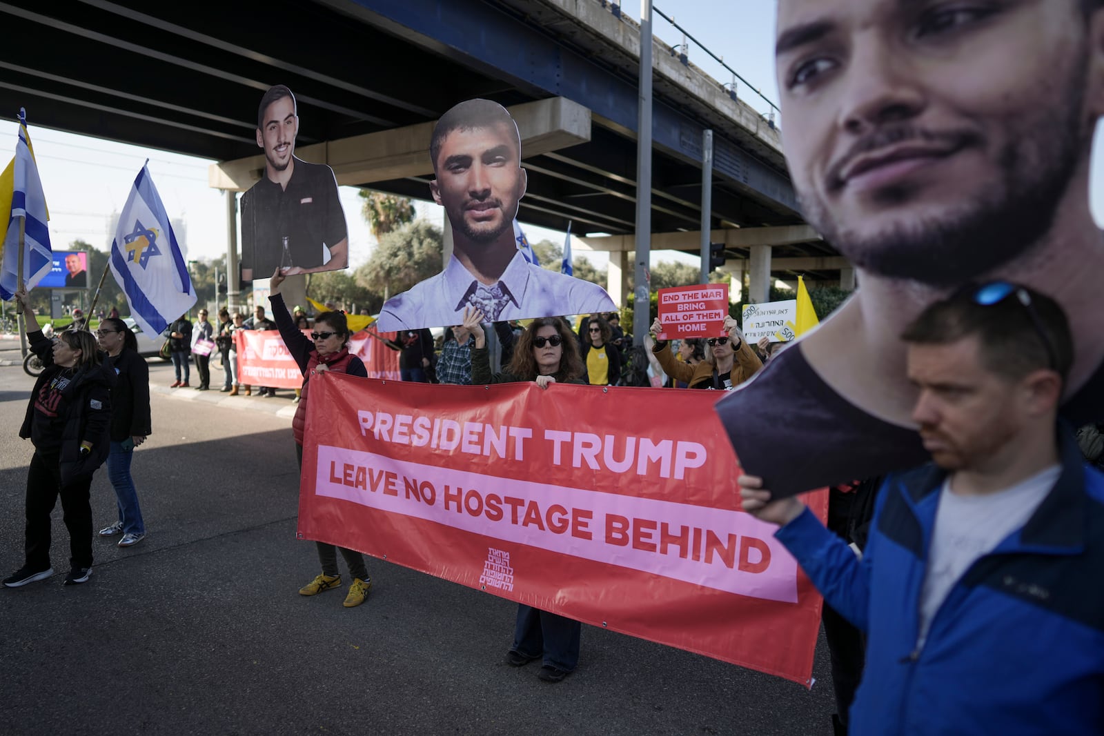 Relatives and supporters of Israelis held hostage in the Gaza Strip, block a freeway during a protest demanding their release from Hamas captivity as they mark 500 days of the Israel-Hamas war in Tel Aviv, Israel, Monday, Feb. 17, 2025. (AP Photo/Oded Balilty)