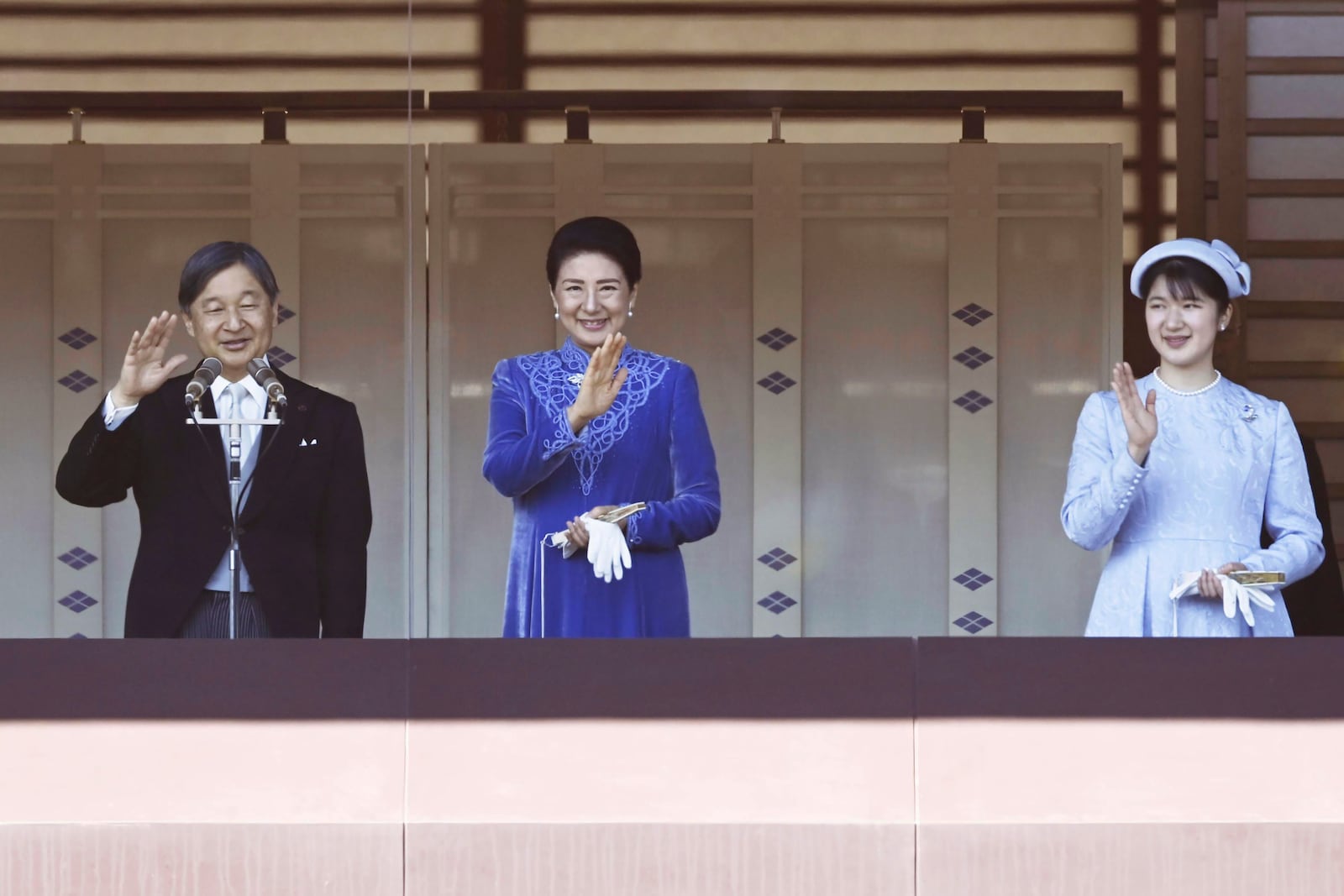 Japanese Emperor Naruhito, accompanied by Empress Masako, center, and their daughter Princess Aiko, waves to well-wishers from the balcony of the Imperial Palace in Tokyo on his 65th birthday, Sunday, Feb. 23, 2025. (Kyodo News via AP)