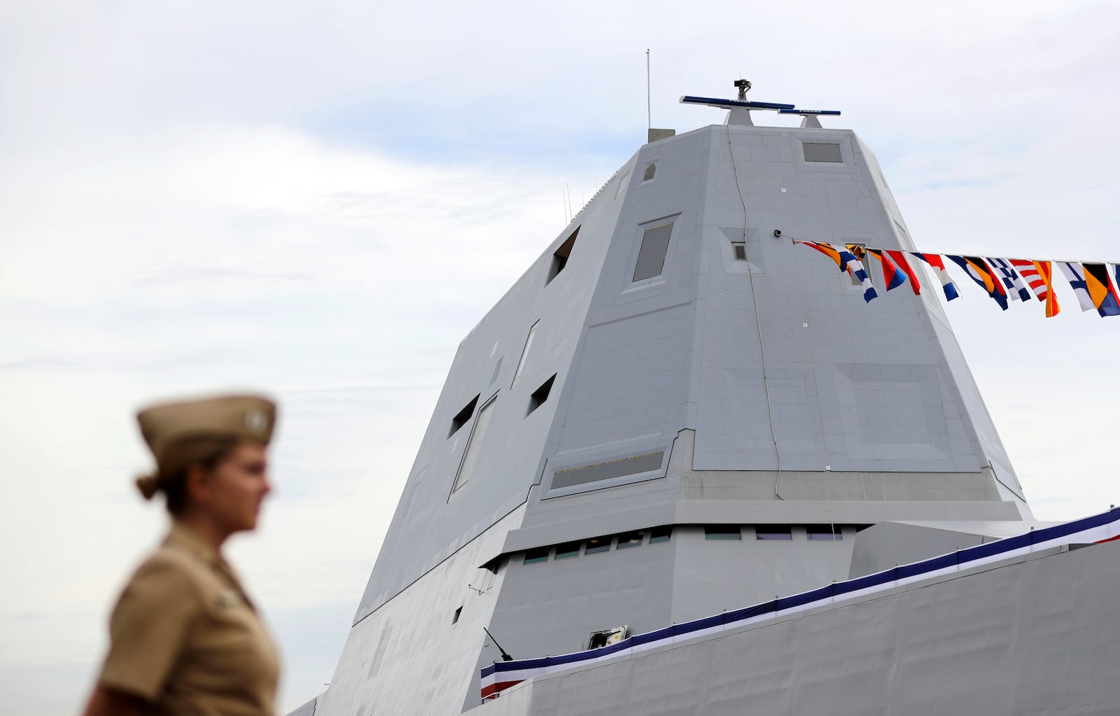 FILE - The deckhouse of the future USS Zumwalt, the U.S. Navy's newest guided-missile destroyer, stands past a member of the U.S. Navy in Baltimore, Oct. 13, 2016. (AP Photo/Patrick Semansky, File)