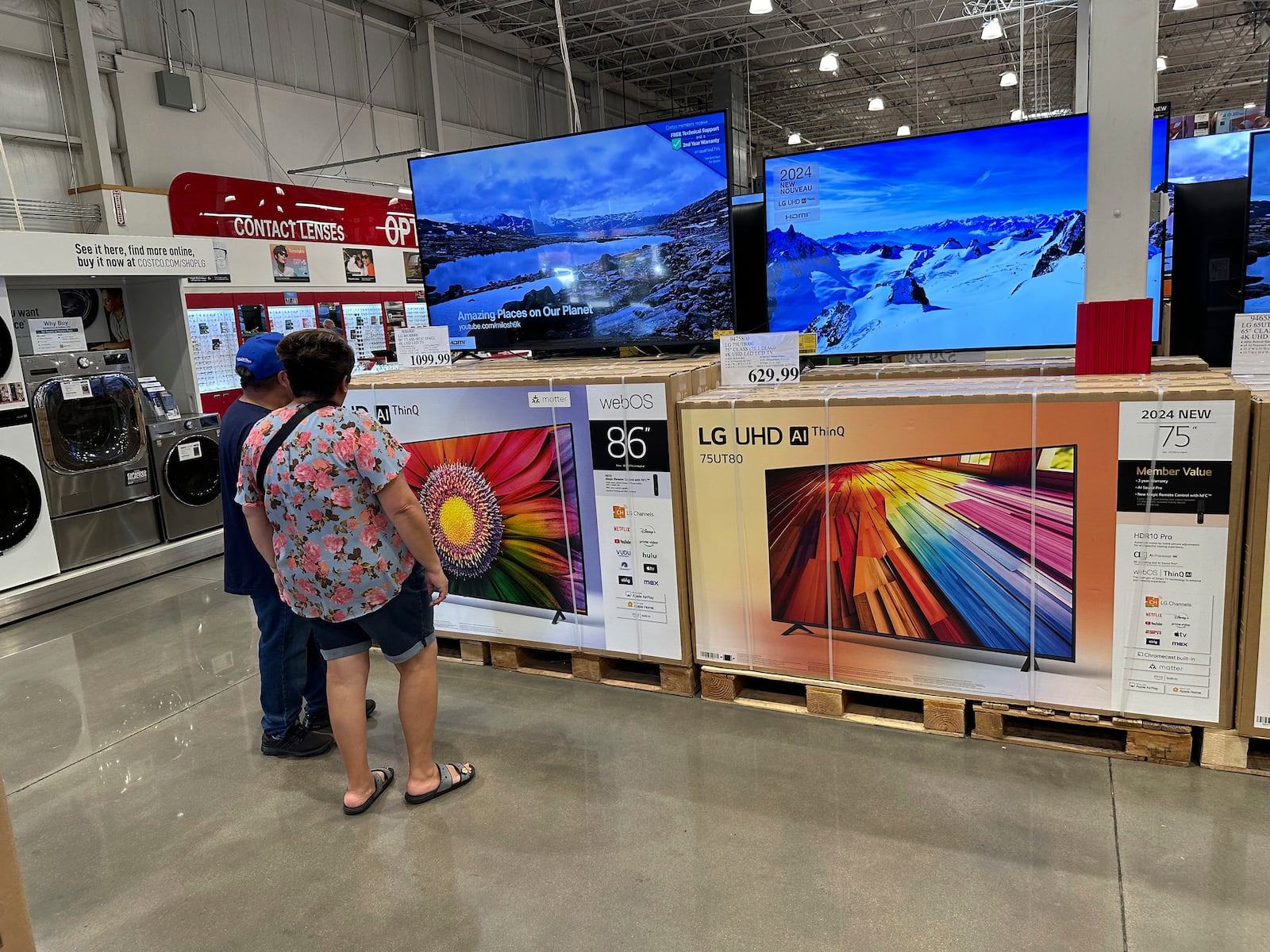 FILE - Shoppers consider big-screen televisions on display in a Costco warehouse Tuesday, Oct. 22, 2024, in Sheridan, Colo. (AP Photo/David Zalubowski, File)