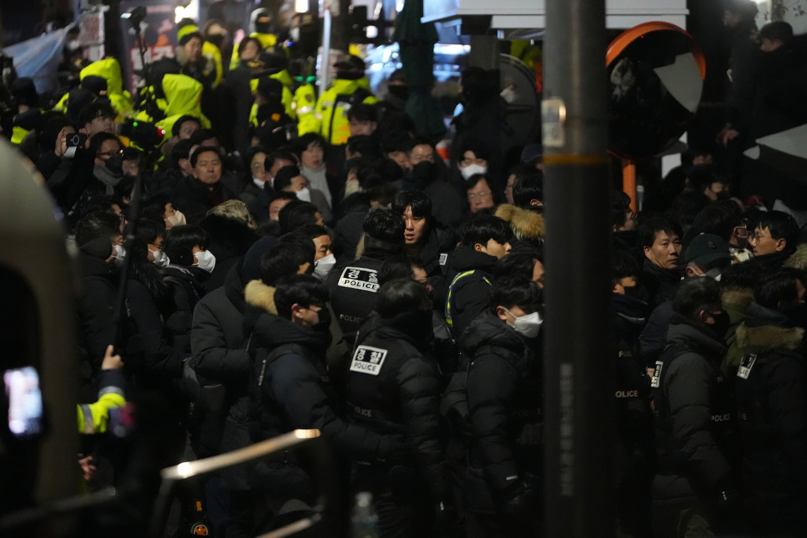 FILE - Police officers try to enter as the members of the ruling People Power Party try to block them in front of the gate of the presidential residence in Seoul, South Korea, on Jan. 15, 2025. (AP Photo/Lee Jin-man, File)