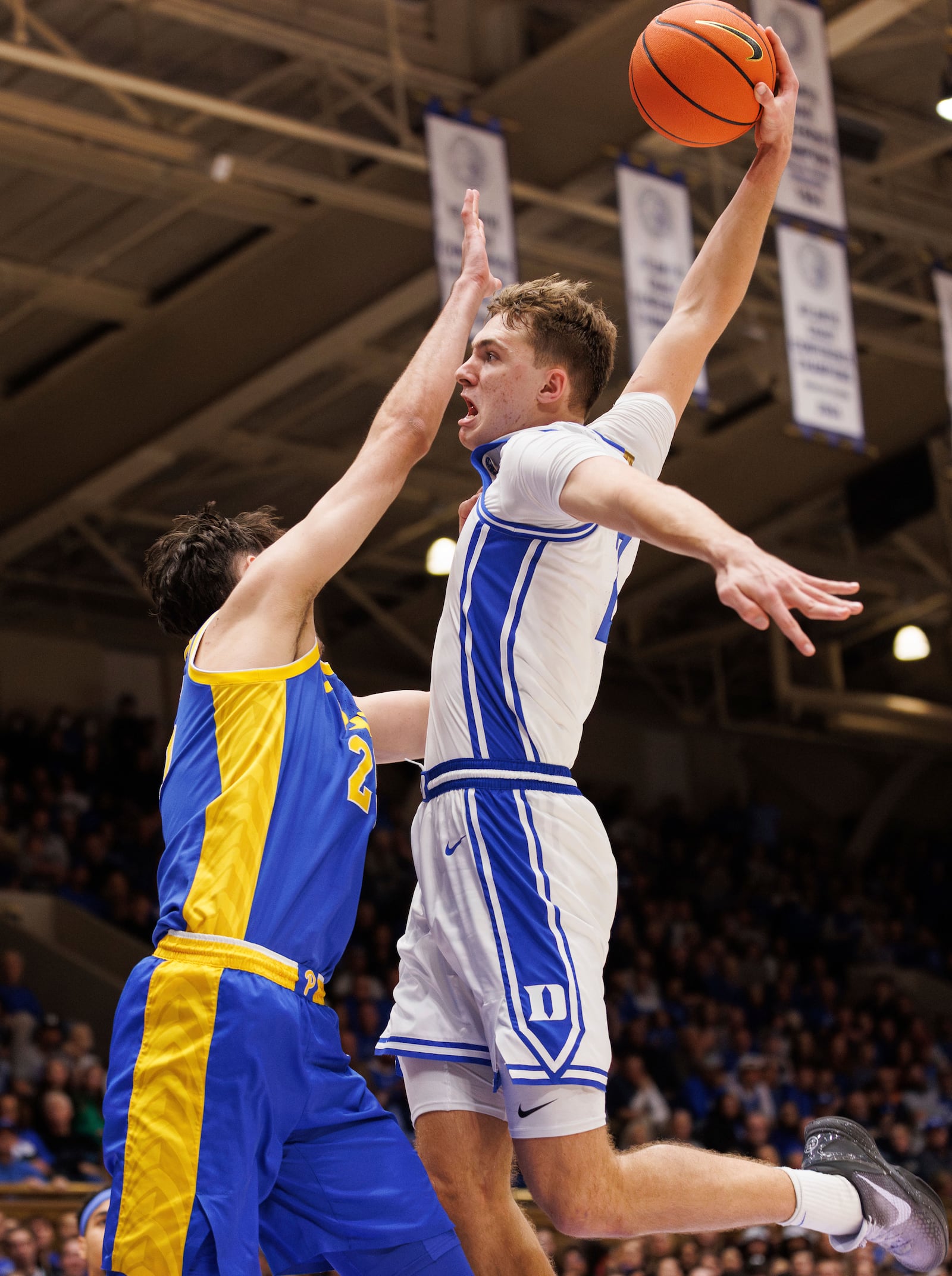 Duke's Cooper Flagg (2) dunks over Pittsburgh's Guillermo Diaz Graham (25) during the second half of an NCAA college basketball game in Durham, N.C., Tuesday, Jan. 7, 2025. (AP Photo/Ben McKeown)