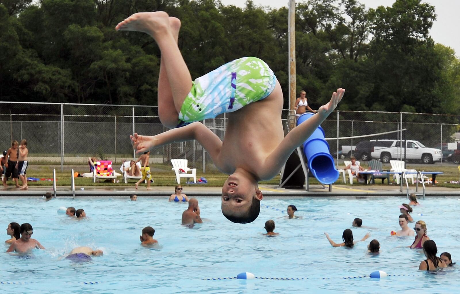 Nash Emberton hangs over the New Carlisle pool as he flips off the diving board. Bill Lackey/Staff