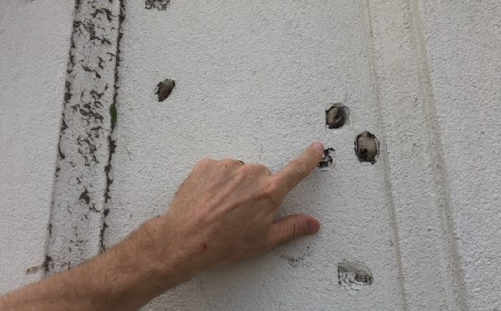 Pebbles from a parking lot are embedded in an exterior wall at the former Abuelo's Mexican restaurant in Beavercreek in the aftermath of a tornado that struck the area Monday night, May 28.