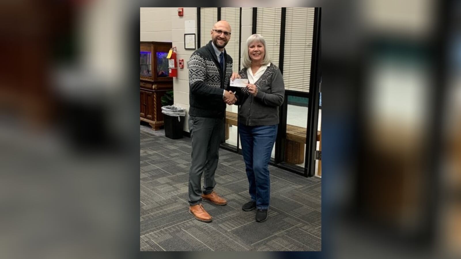 The Champaign County Democrats paid off over $1,240 in school lunch debt for students at Graham Local, Triad Local and Mechanicsburg Exempted Village schools. In this photo is Treasurer Dianne Burroughs (right) and Superintendent Chad Lensman (left). Contributed