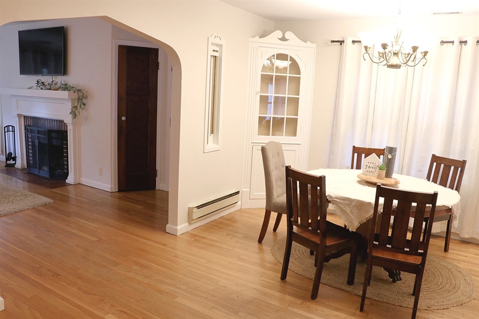 Hardwood flooring fills the dining room and flows into the formal living room.