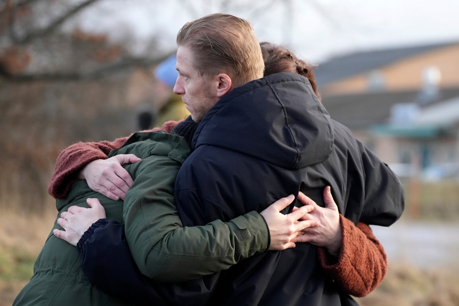 People gather at a makeshift memorial near the scene of a shooting on the outskirts of Orebro, Sweden, Wednesday, Feb. 5, 2025. (AP Photo/Sergei Grits)