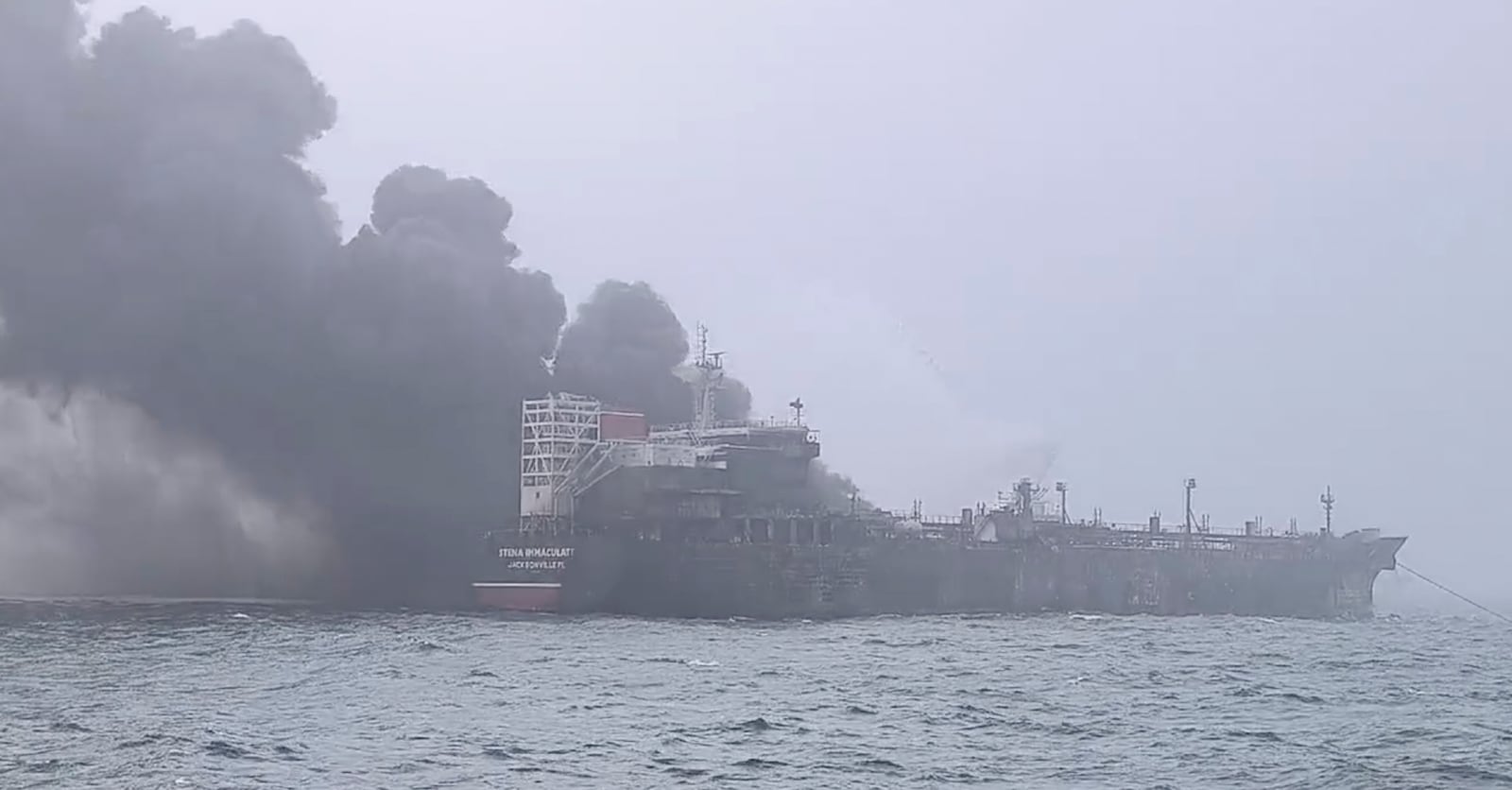 In this image taken from video provided by Denys Mezentsev, rescue crews work on site after a cargo ship was hit by a tanker carrying jet fuel for the U.S. military off eastern England, Monday, March 10, 2025, setting both vessels ablaze and sending fuel pouring into the North Sea. (Denys Mezentsev via AP)