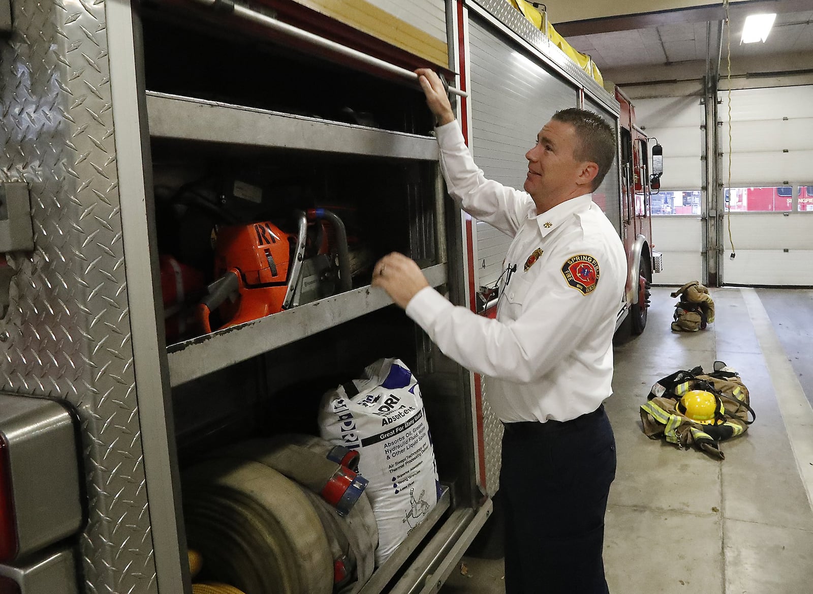 Springfield Assistant Fire Chief Brian Miller opens open of the side compartments on the city’s rescue truck Thursday. The city plans to purchase three new medic units and a new rescue truck to update their aging vehicles. Bill Lackey/Staff