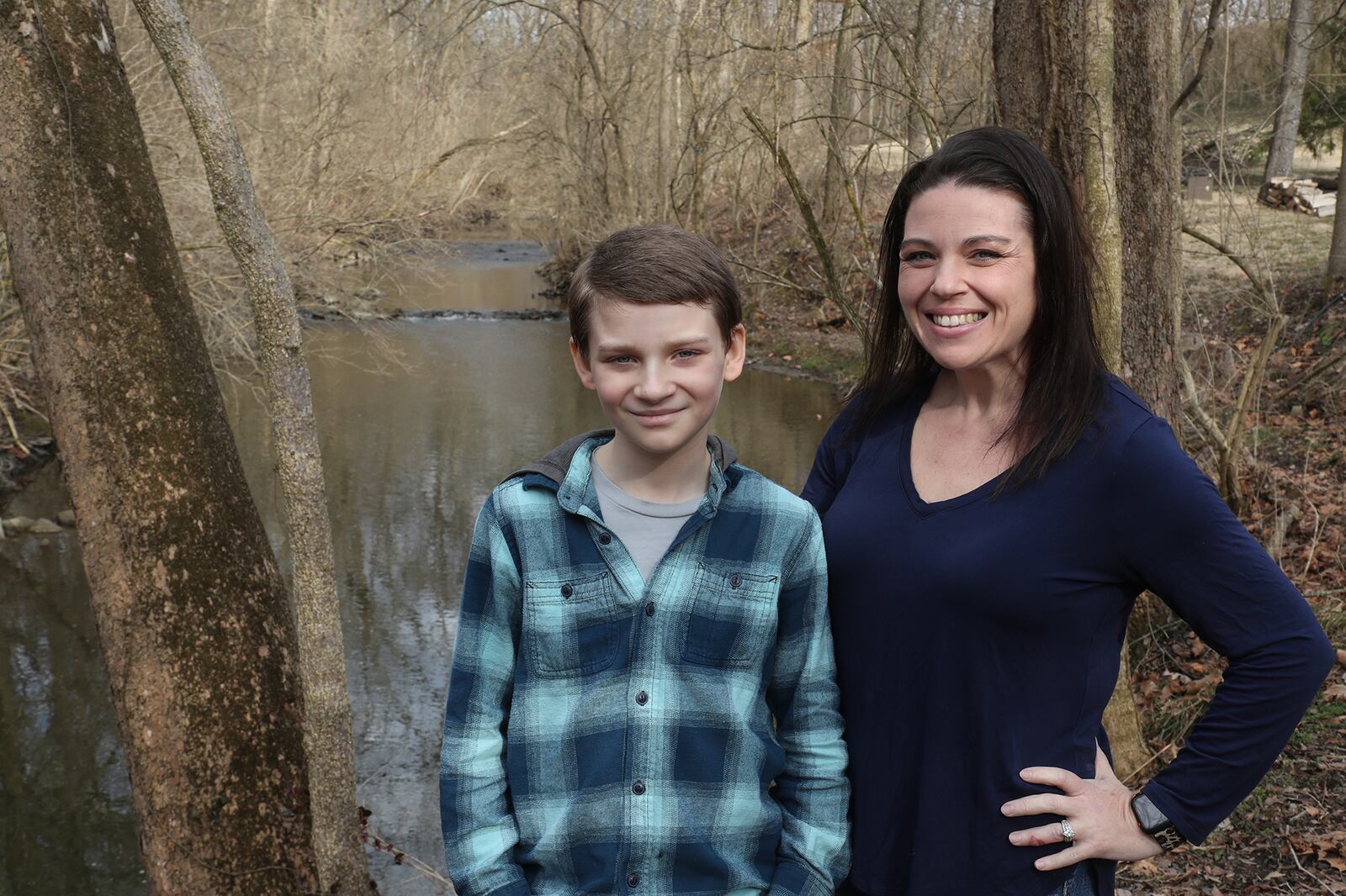 Because they can't go out due to COVID-19, Keli Henley and her son, Jack, spend alot of time by the stream in her back yard. BILL LACKEY/STAFF