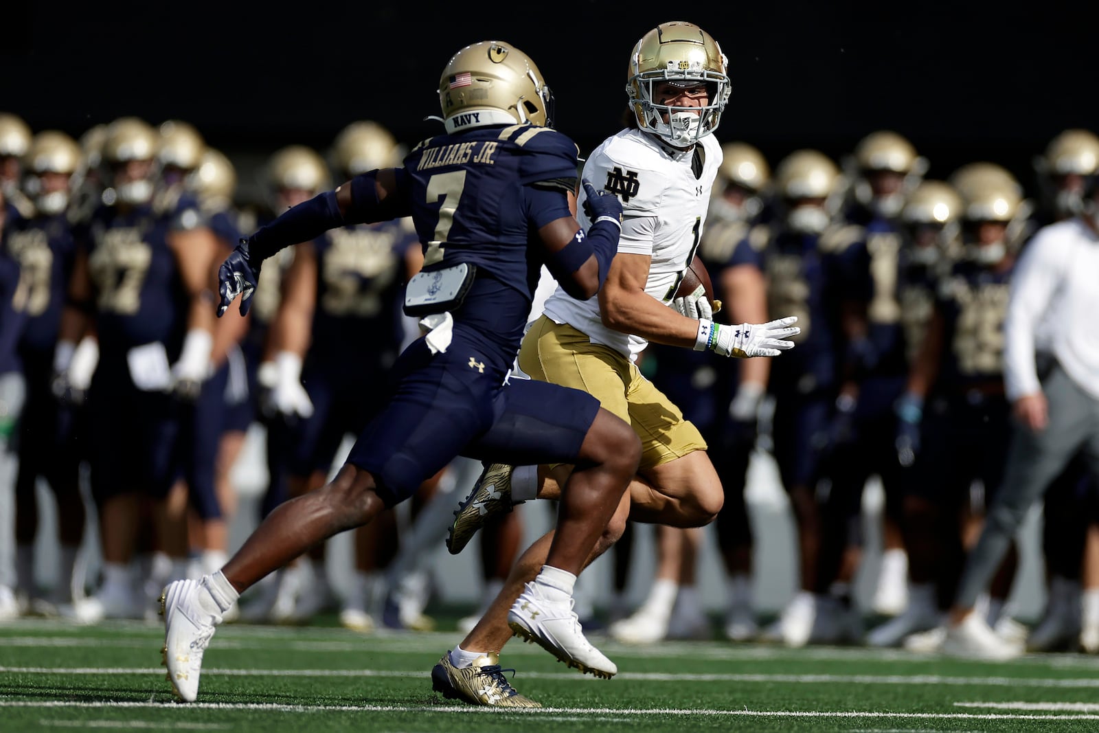 Notre Dame wide receiver Jaden Greathouse (1) runs with the ball past Navy linebacker Mbiti Williams Jr. (7) during the first half of an NCAA college football game Saturday, Oct. 26, 2024, in East Rutherford, N.J. (AP Photo/Adam Hunger)