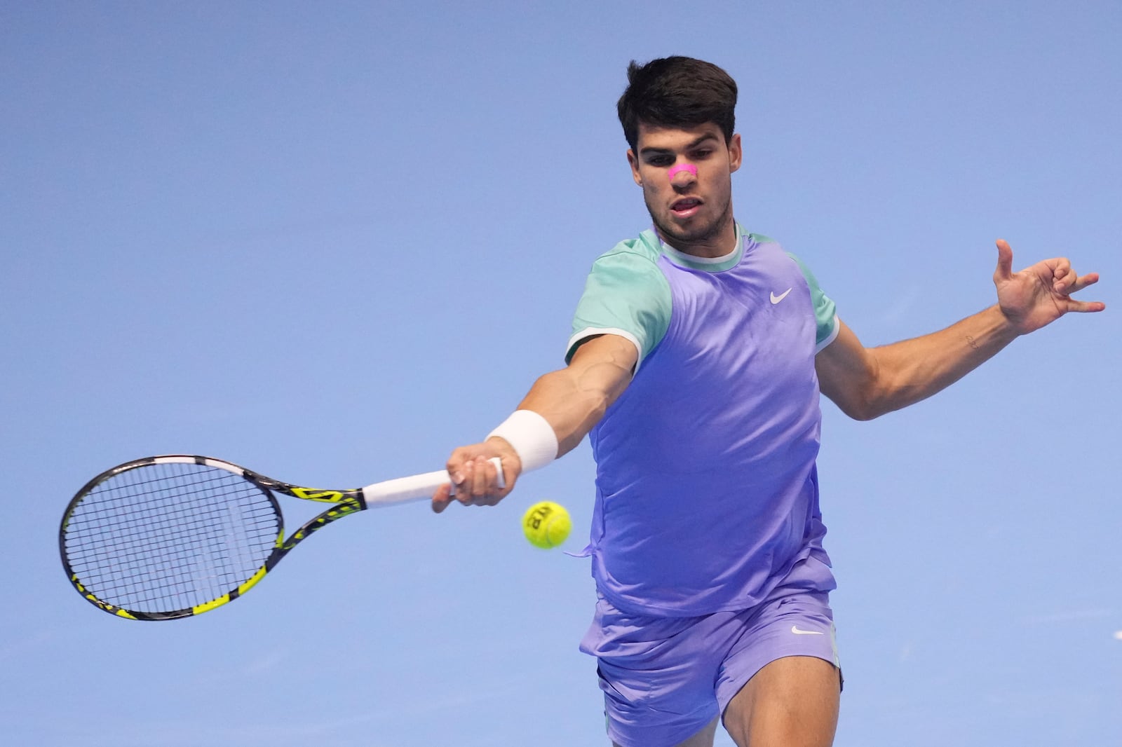 Spain's Carlos Alcaraz returns the ball to Germany's Alexander Zverev during their singles tennis match of the ATP World Tour Finals at the Inalpi Arena, in Turin, Italy, Friday, Nov. 15, 2024. (AP Photo/Antonio Calanni)