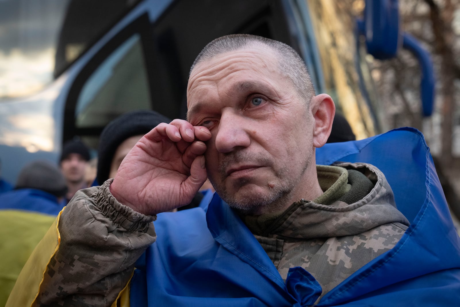 A Ukrainian serviceman reacts after returning from captivity during a POWs exchange between Russia and Ukraine, in Chernyhiv region, Ukraine, Wednesday, March 19, 2025. (AP Photo/Efrem Lukatsky)