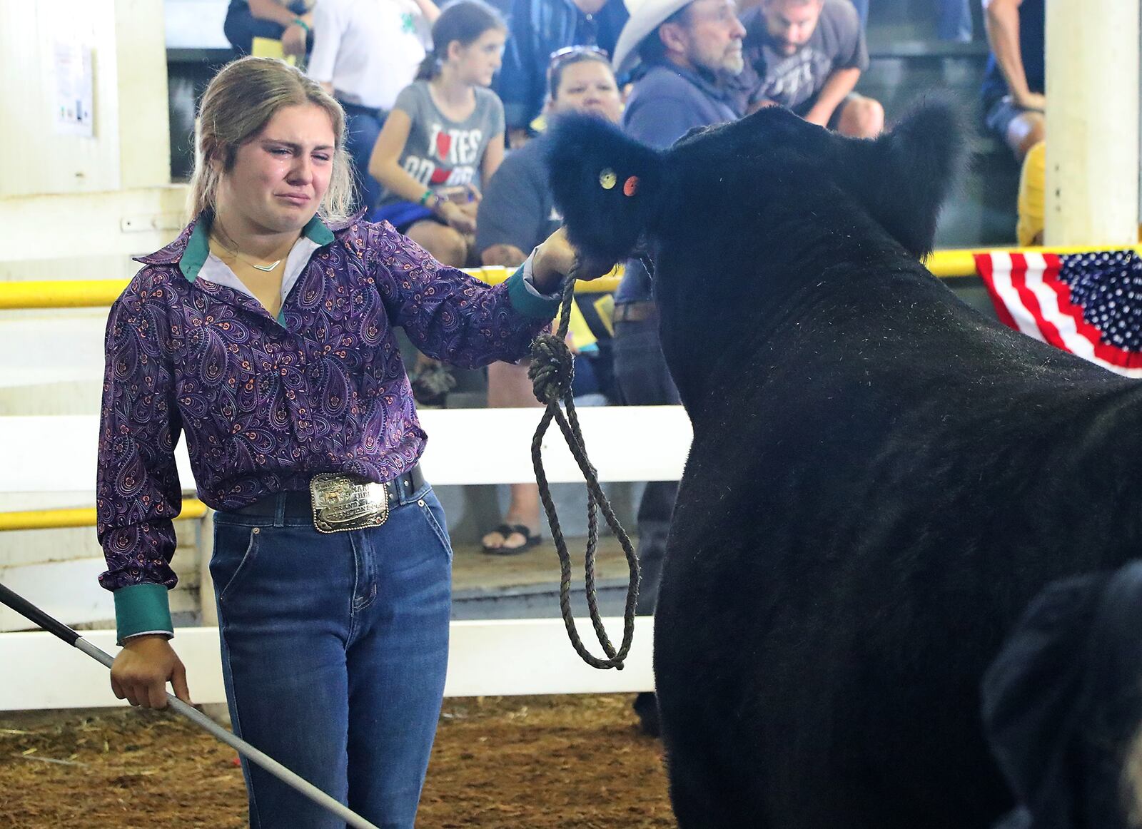 Tears roll down Kendall Bishop's face Friday, July 29, 2022 as she auctions off her Grand Champion steer that she's spent the past year raising during the Clark County Champion Showcase and Junior Fair Auction. BILL LACKEY/STAFF