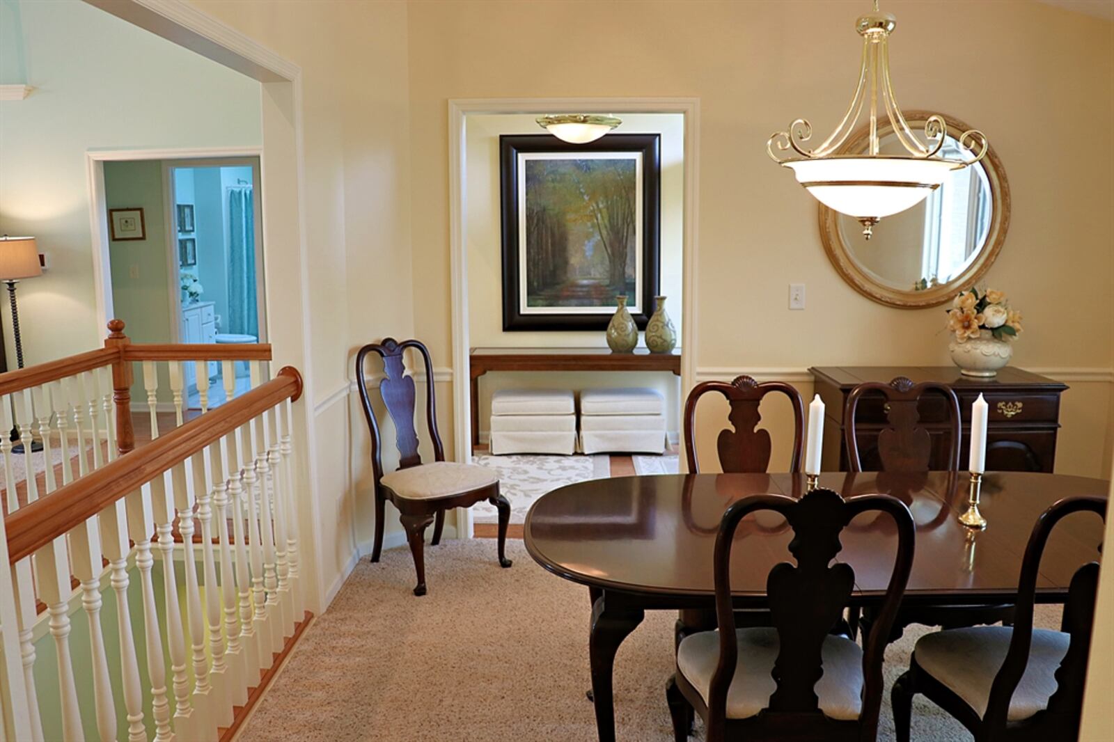 The formal dining room has a chair rail and railing that surrounds the open stairwell to the lower level. 