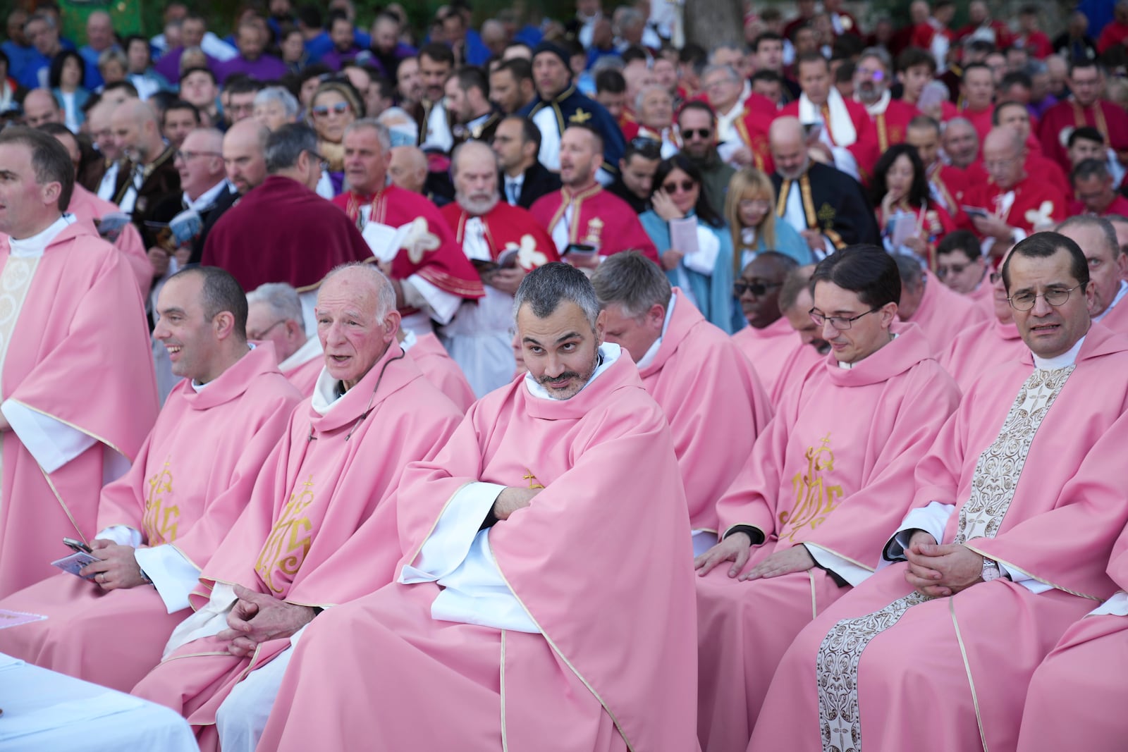 Priests wait for the start of a mass celebrated by Pope Francis in Ajaccio "Place d'Austerlitz" during his visit in the French island of Corsica, Sunday, Dec. 15, 2024. (AP Photo/Alessandra Tarantino)