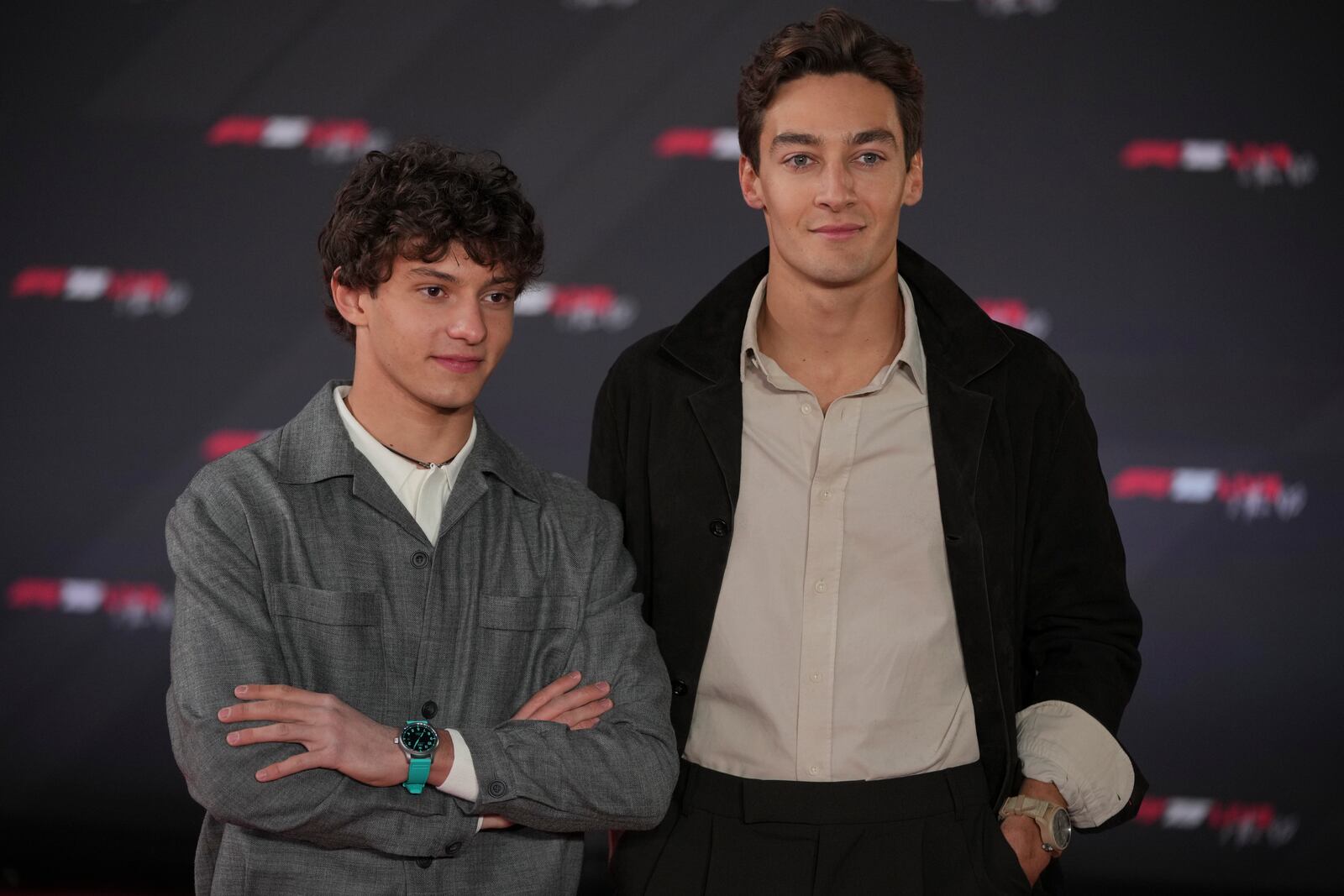 Mercedes driver Andrea Kimi Antonelli of Italy, left, and Mercedes driver George Russell of Britain pose for cameras as they arrive to the F1@75 launch event at the O2 arena in London, Tuesday, Feb. 18, 2025. (AP Photo/Kin Cheung)