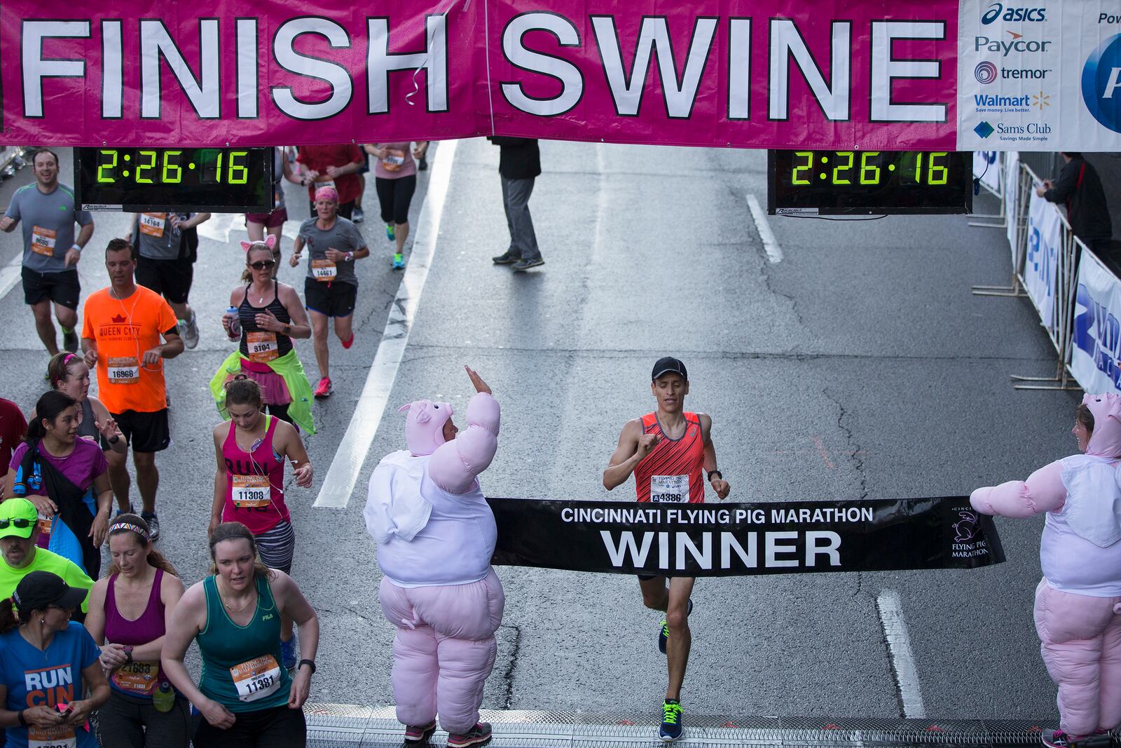 Sergio Reyes wins the men’s division of the 18th Annual Flying Pig Marathon, Sunday, May 1, 2016, in Cincinnati. Reyes recorded his fifth win of the marathon. (AP Photo/John Minchillo)