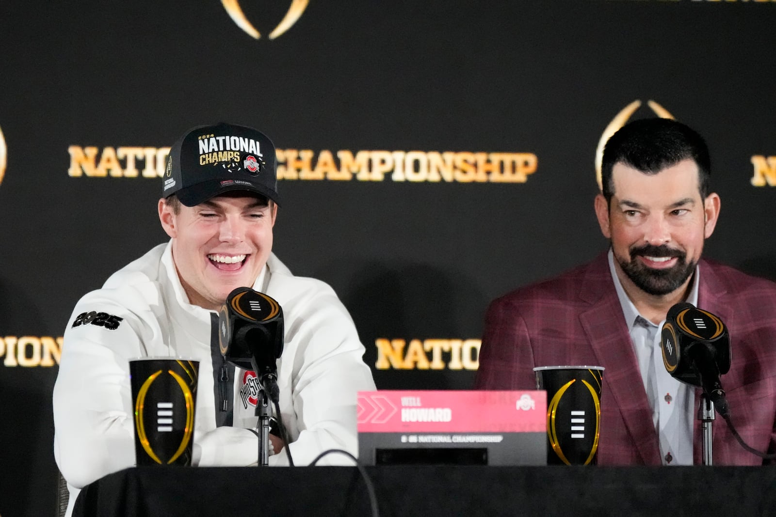 Ohio State quarterback Will Howard and head coach Ryan Day participate in the winners news conference after the College Football Playoff national championship game against Notre Dame Tuesday, Jan. 21, 2025, in Atlanta. (AP Photo/Chris Carlson)