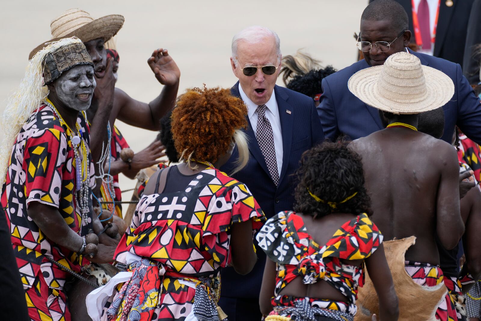 President Joe Biden watches a traditional dance after arriving at Catumbela airport in Angola on Wednesday, Dec. 4, 2024. (AP Photo/Ben Curtis)