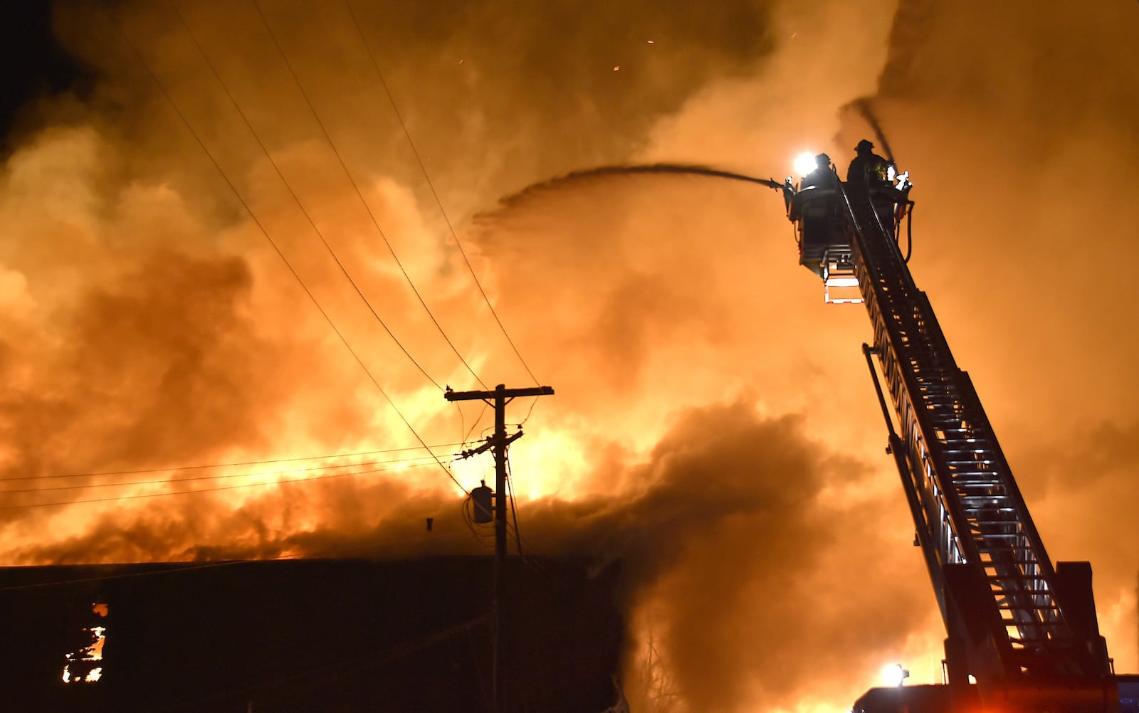 Members of the Springfield Fire Division battle a five alarm fire at Tri-State Pallet in downtown Springfield on Jan. 6, 2015. Bill Lackey/Staff