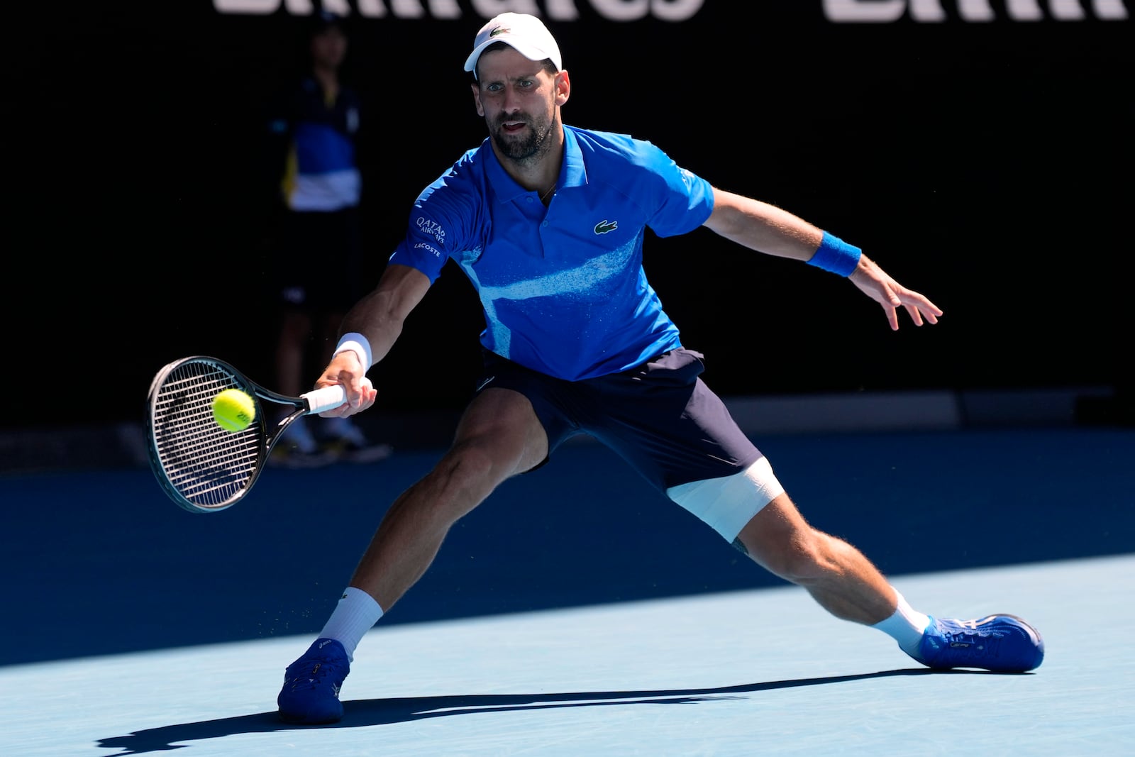 Novak Djokovic of Serbia plays a forehand return to Alexander Zverev of Germany during their semifinal match at the Australian Open tennis championship in Melbourne, Australia, Friday, Jan. 24, 2025. (AP Photo/Ng Han Guan)