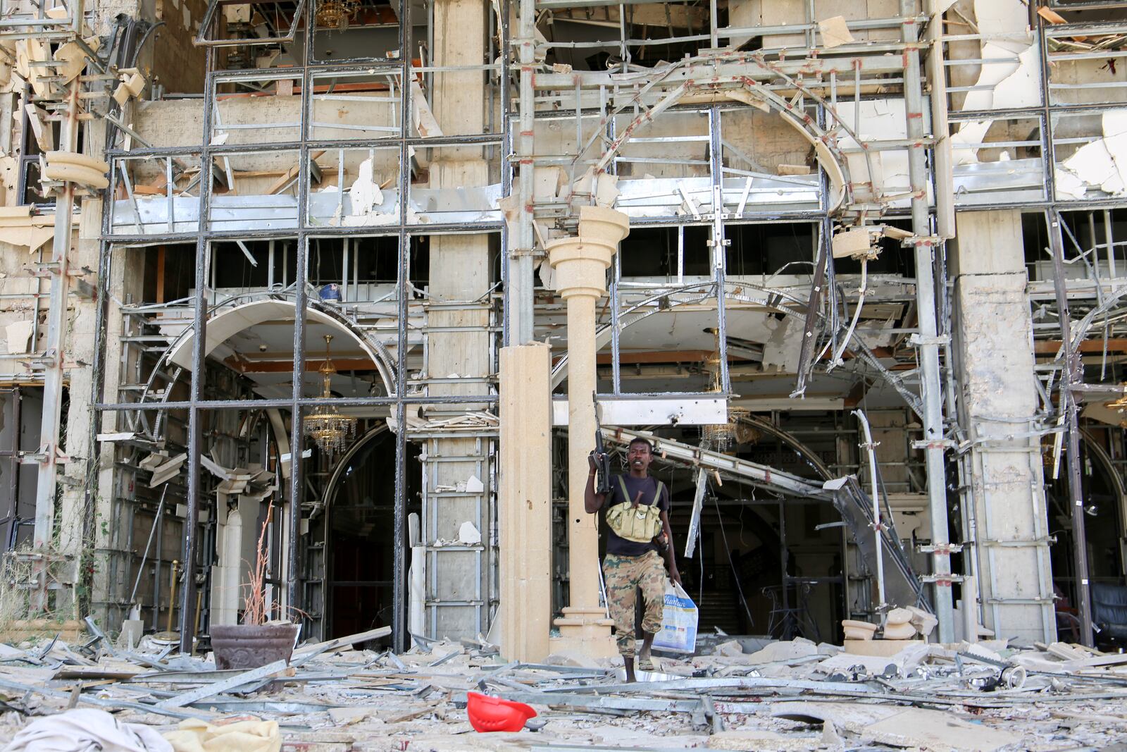 An army soldier walks in front of the damaged Republican Palace in Khartoum, Sudan, after it was taken over by Sudan's army Friday, March 21, 2025. (AP Photo)