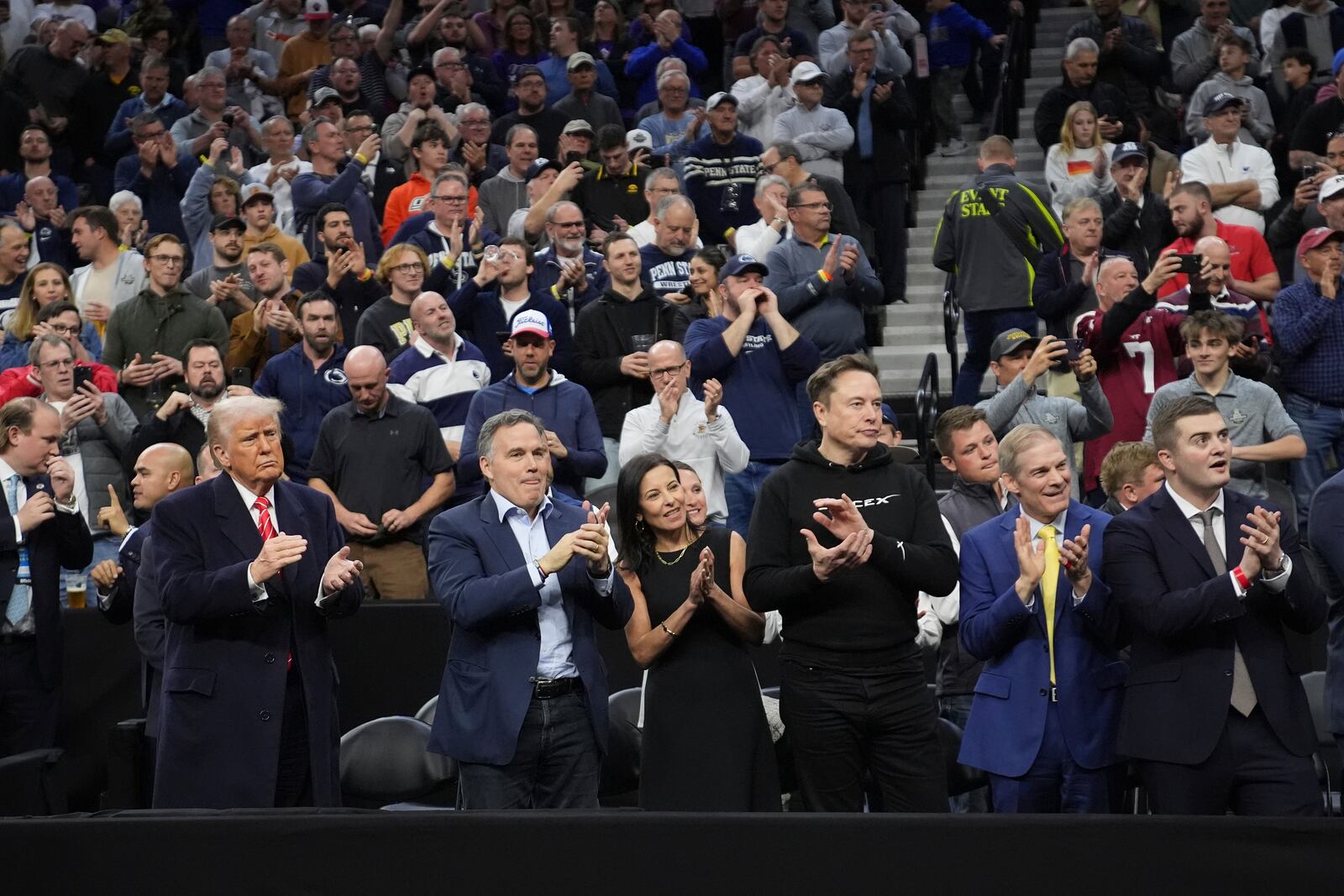 President Donald Trump, left, Sen. Dave McCormick, R-Pa., second from left, and Elon Musk, third from right, attend the finals at the NCAA wrestling championship, Saturday, March 22, 2025, in Philadelphia. (AP Photo/Matt Rourke)