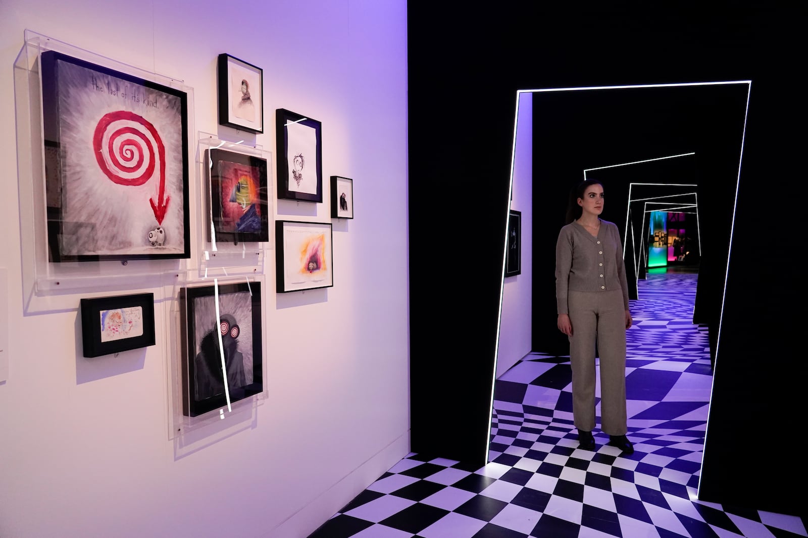 A member of staff poses at The World of Tim Burton exhibition at the Design Museum, in London, Monday, Oct. 21, 2024. The major exhibition sees Tim Burton's personal archives on display for the first time, featuring 600 items from his nearly fifty years long career. (AP Photo/Alberto Pezzali)