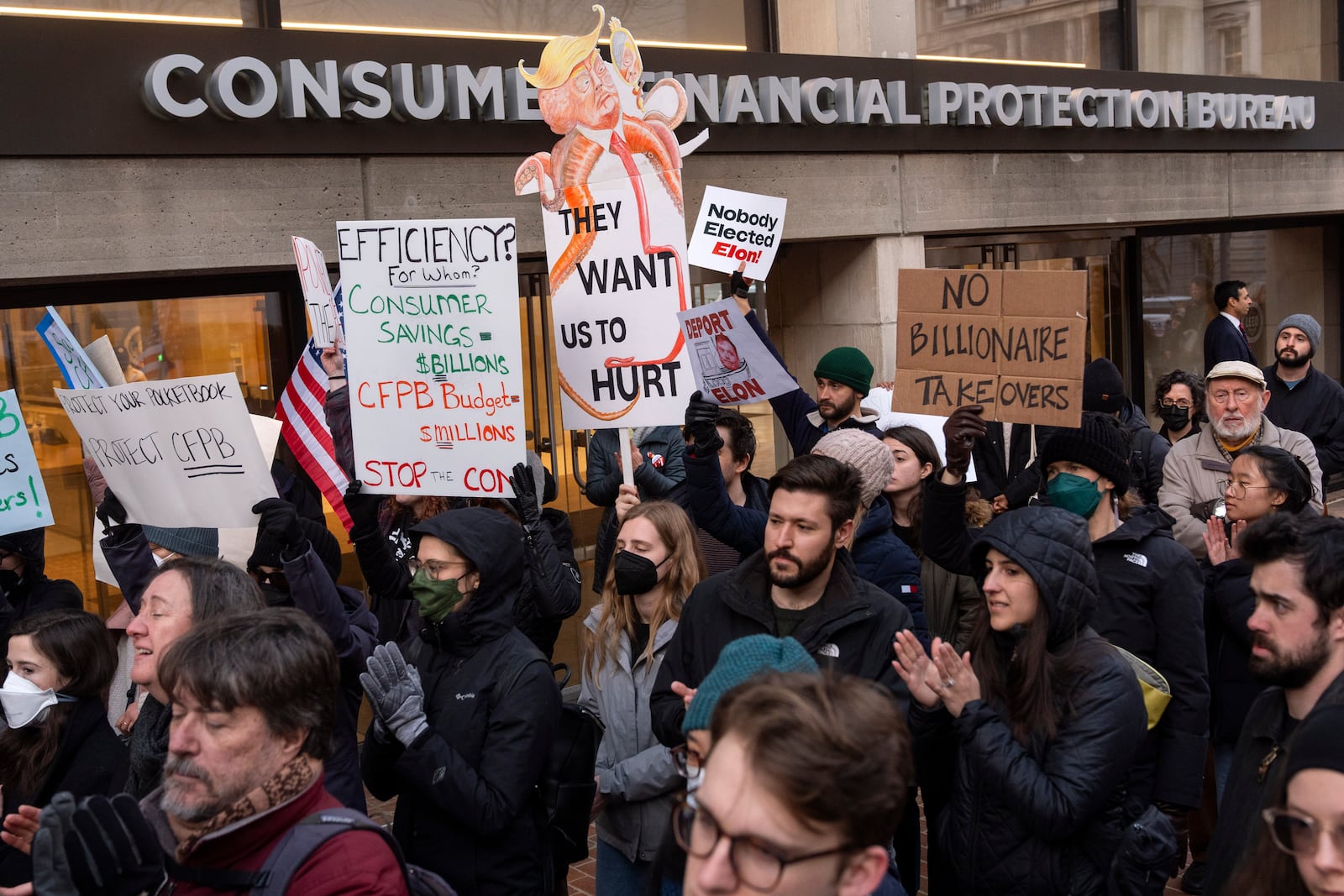 People attend a protest in support of the Consumer Financial Protection Bureau (CFPB), Monday, Feb. 10, 2025, at the CFPB headquarters in Washington. (AP Photo/Jacquelyn Martin)