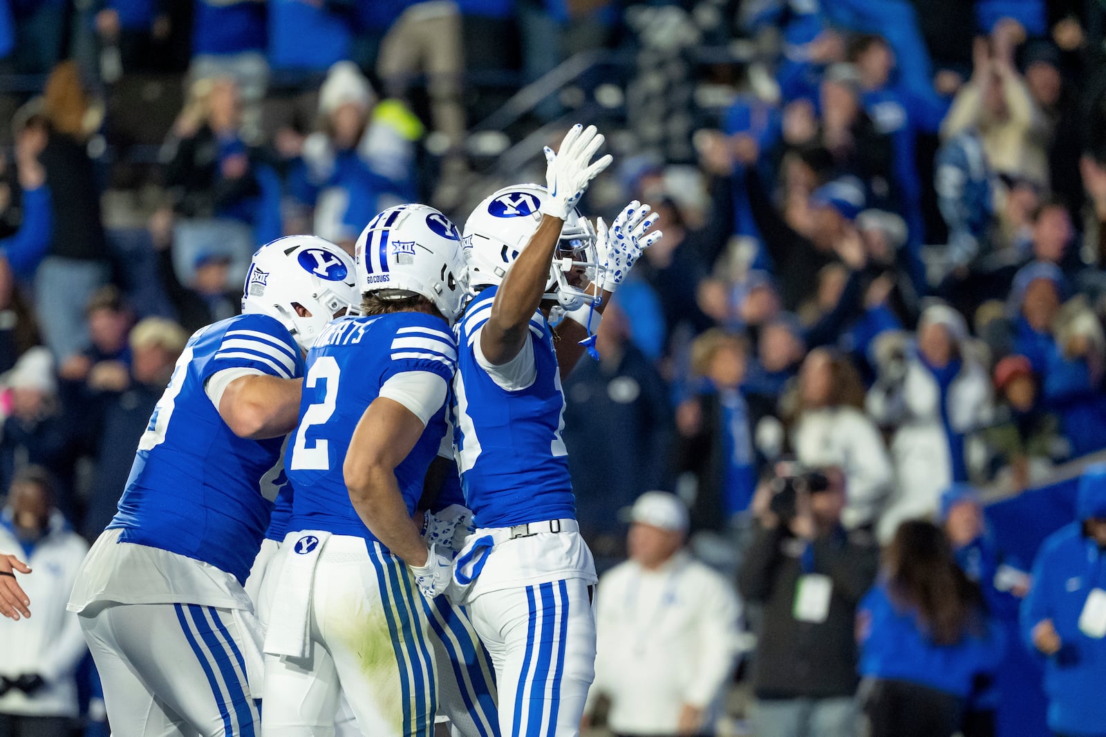 BYU wide receiver Jojo Phillips, right, and teammates celebrate after wide receiver Darius Lassiter scored to take the lead over Oklahoma State with 10 seconds on the clock in the second half of an NCAA college football game, Friday, Oct. 18, 2024, in Provo, Utah. (AP Photo/Spenser Heaps)