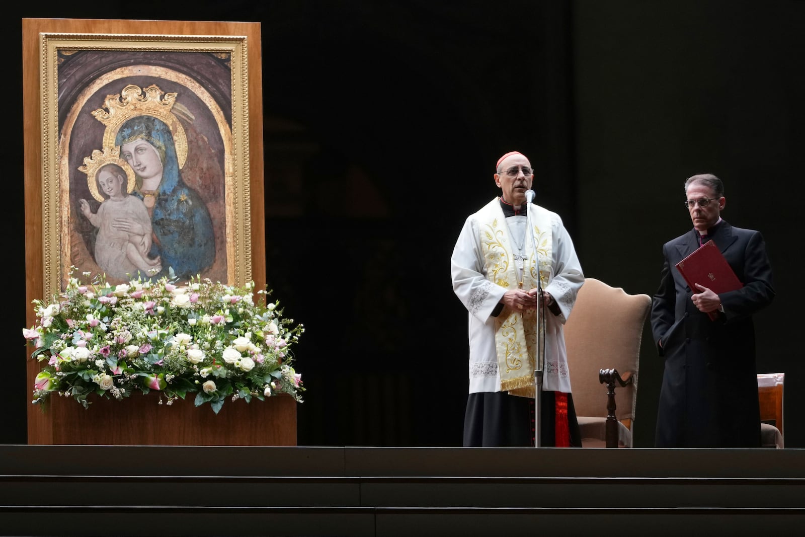 Cardinal Victor Manuel Fernandez, left, prays during a rosary prayer held for the health of Pope Francis in St Peter's Square at The Vatican, Friday, Feb. 28, 2025. (AP Photo/Kirsty Wigglesworth)